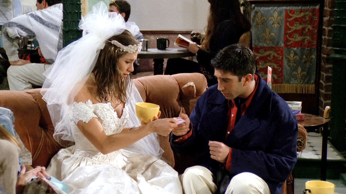 Close-up of Rachel's runaway bride look—lace wedding dress, tulle veil, and pearl choker