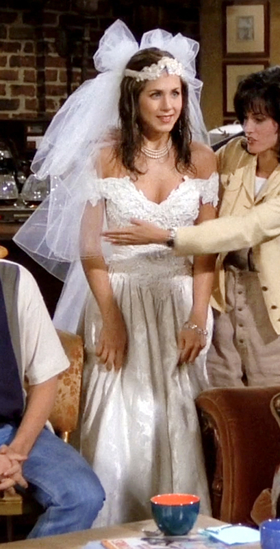 Close-up of Rachel's runaway bride look—lace wedding dress, tulle veil, and pearl choker