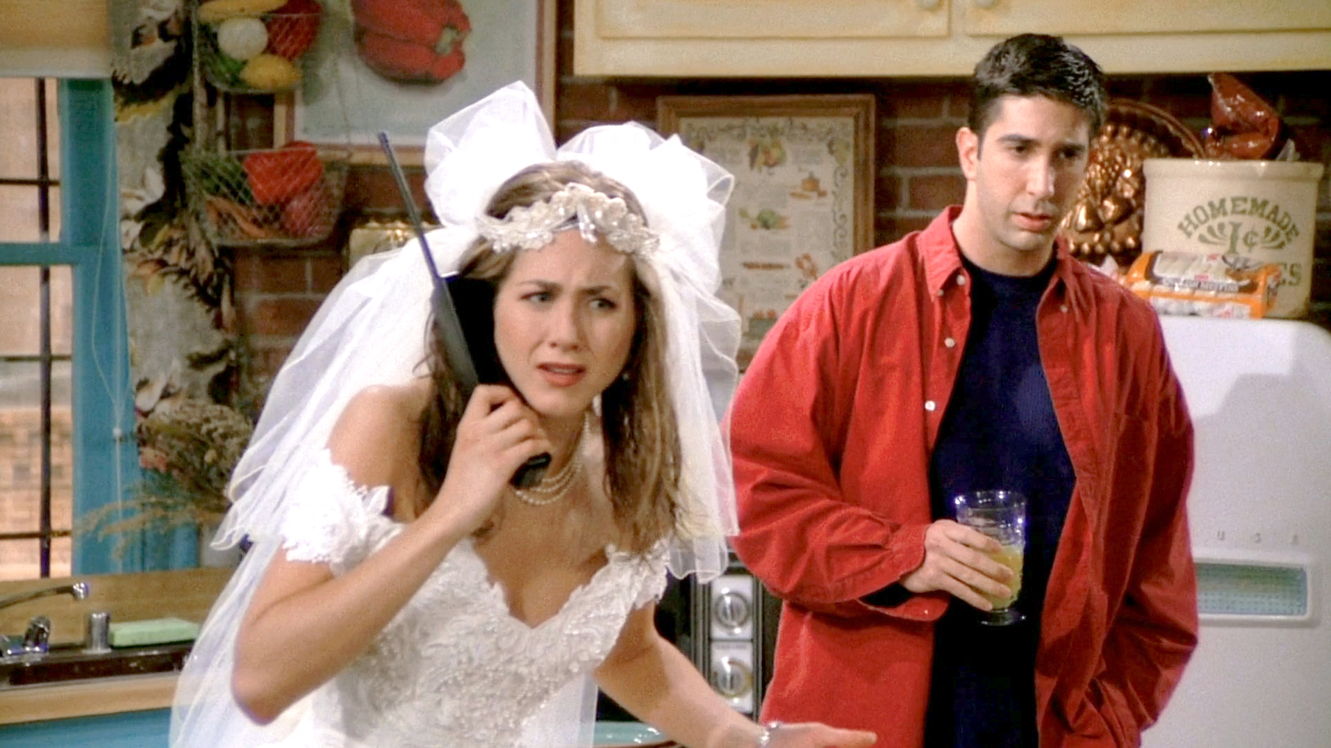 Close-up of Rachel's runaway bride look—lace wedding dress, tulle veil, and pearl choker