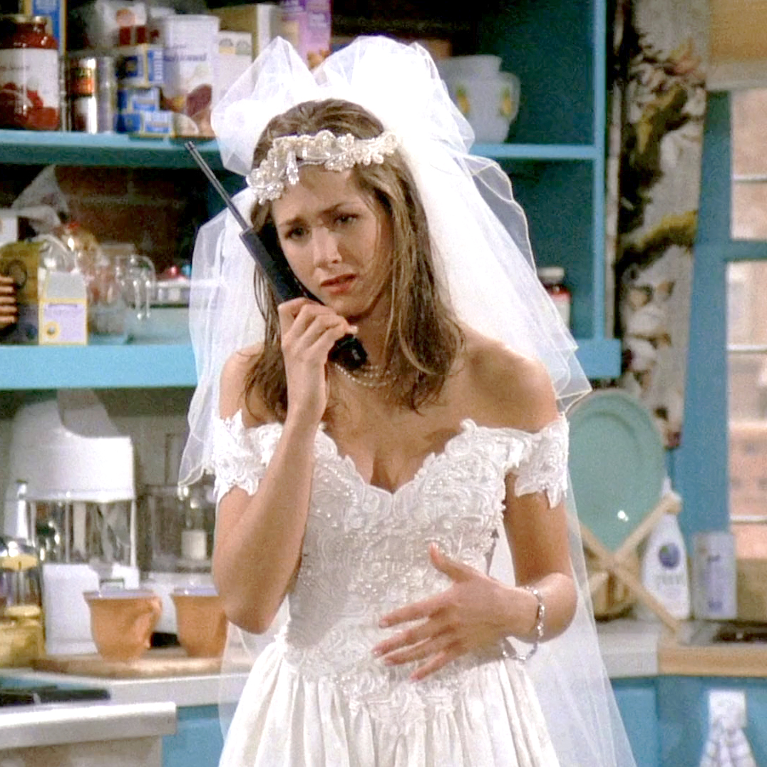 Close-up of Rachel's runaway bride look—lace wedding dress, tulle veil, and pearl choker