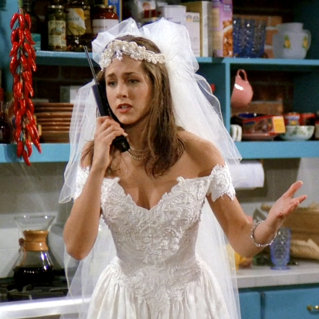 Close-up of Rachel's runaway bride look—lace wedding dress, tulle veil, and pearl choker