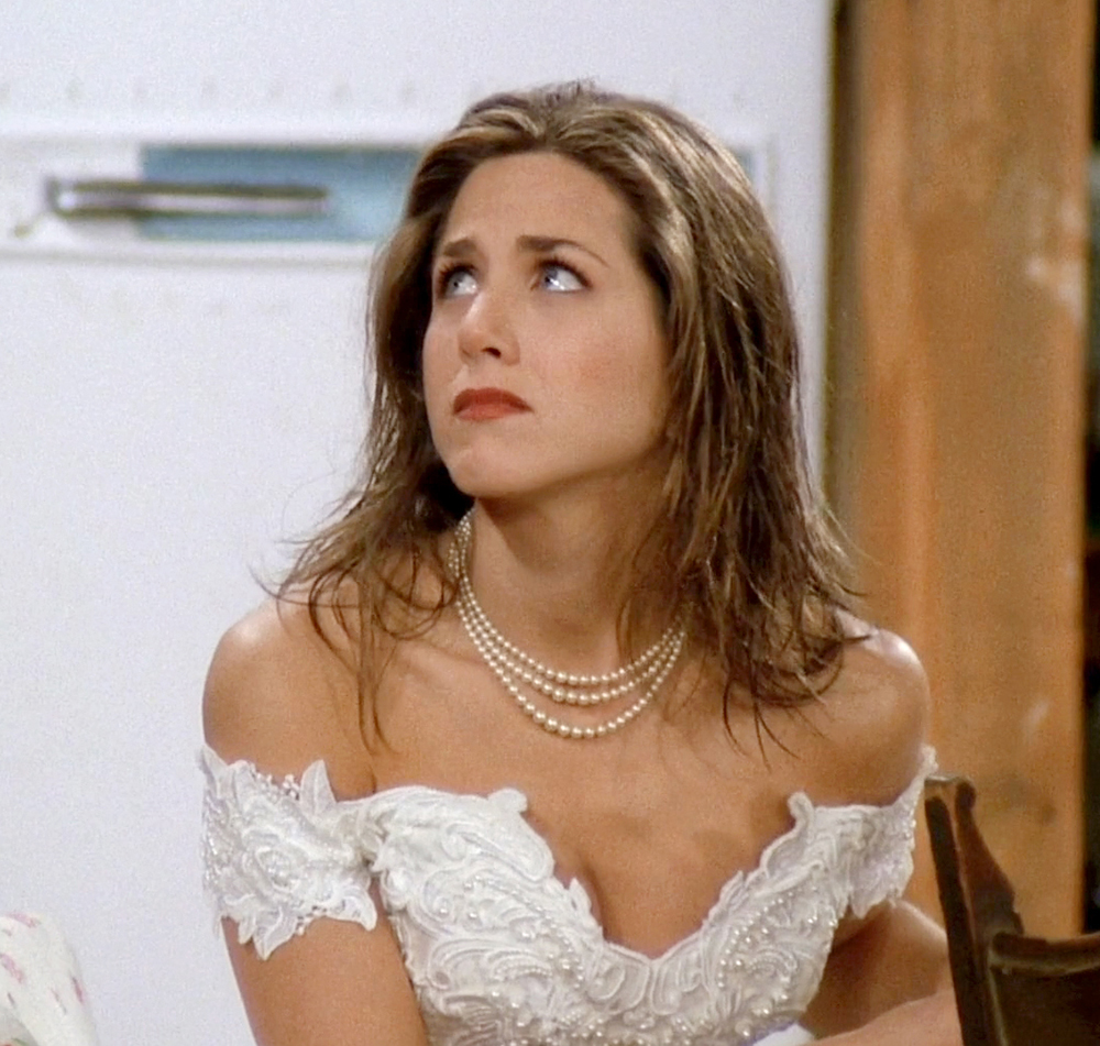 Close-up of Rachel's runaway bride look—lace wedding dress, tulle veil, and pearl choker