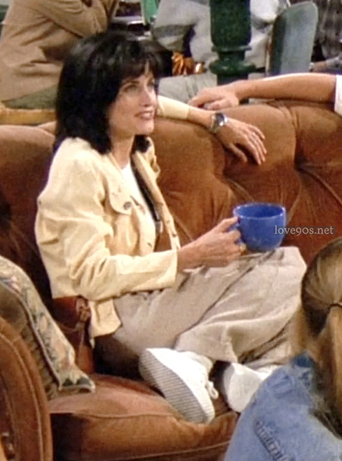 Monica in pale yellow jacket and white ribbed tee at Central Perk, Friends S1E1