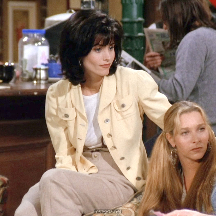 Monica in pale yellow jacket and white ribbed tee at Central Perk, Friends S1E1