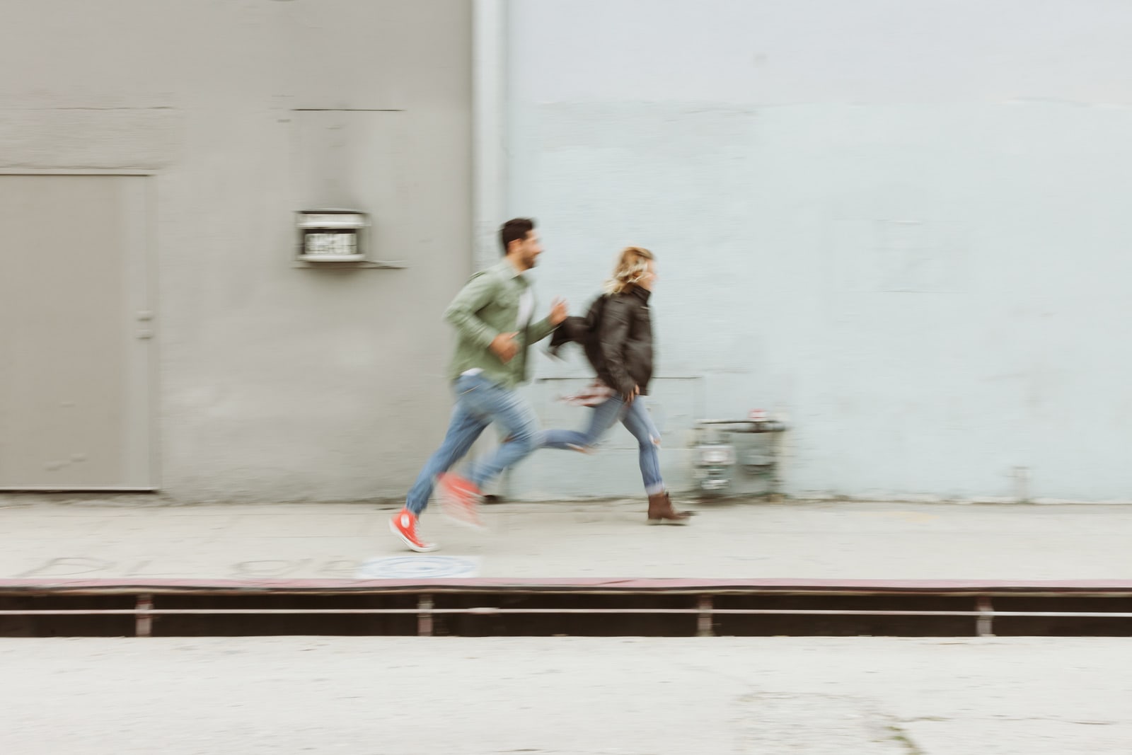 A couple running together, laughing