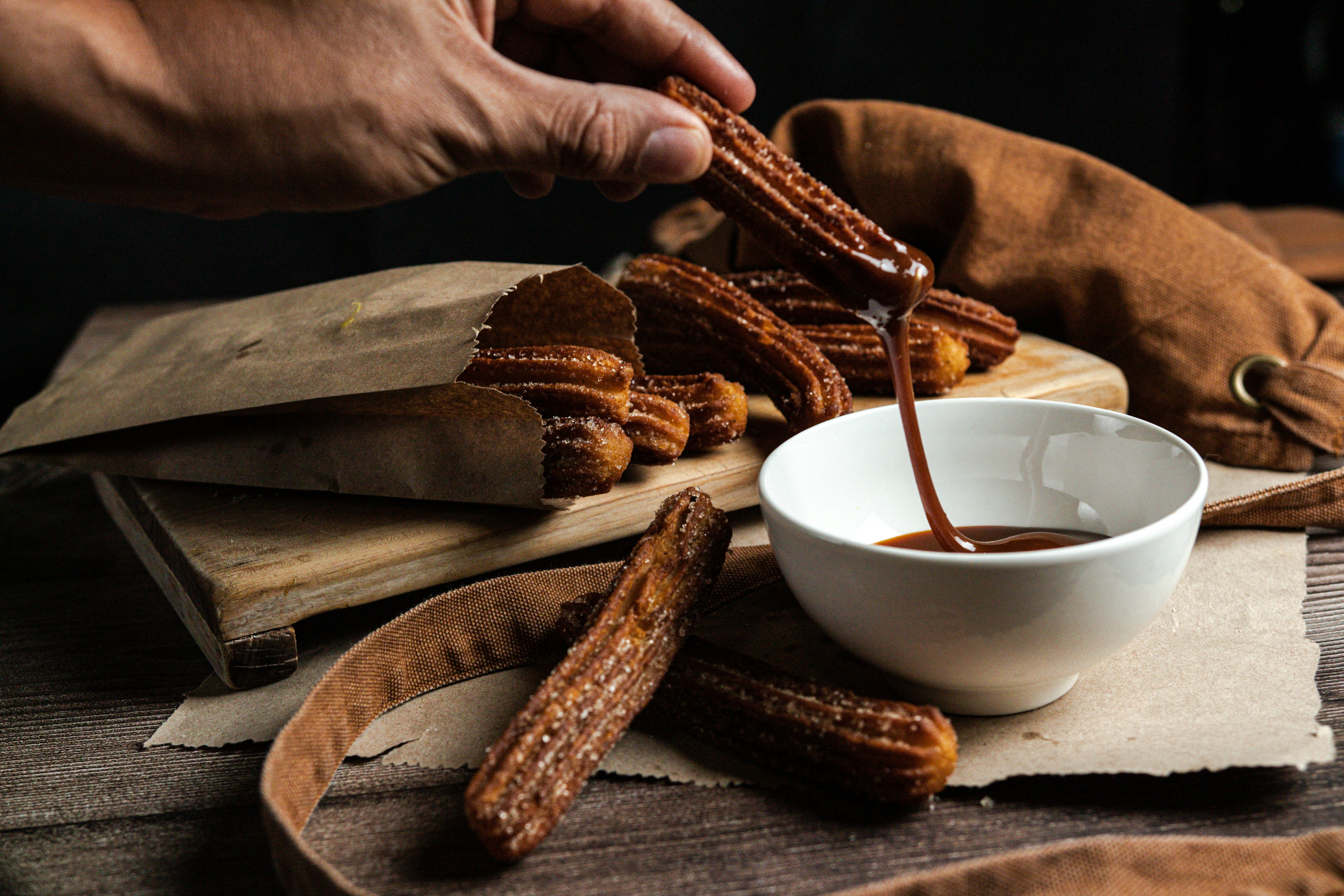 A cortado or café con leche on a café table, or a churros-and-chocolate scene