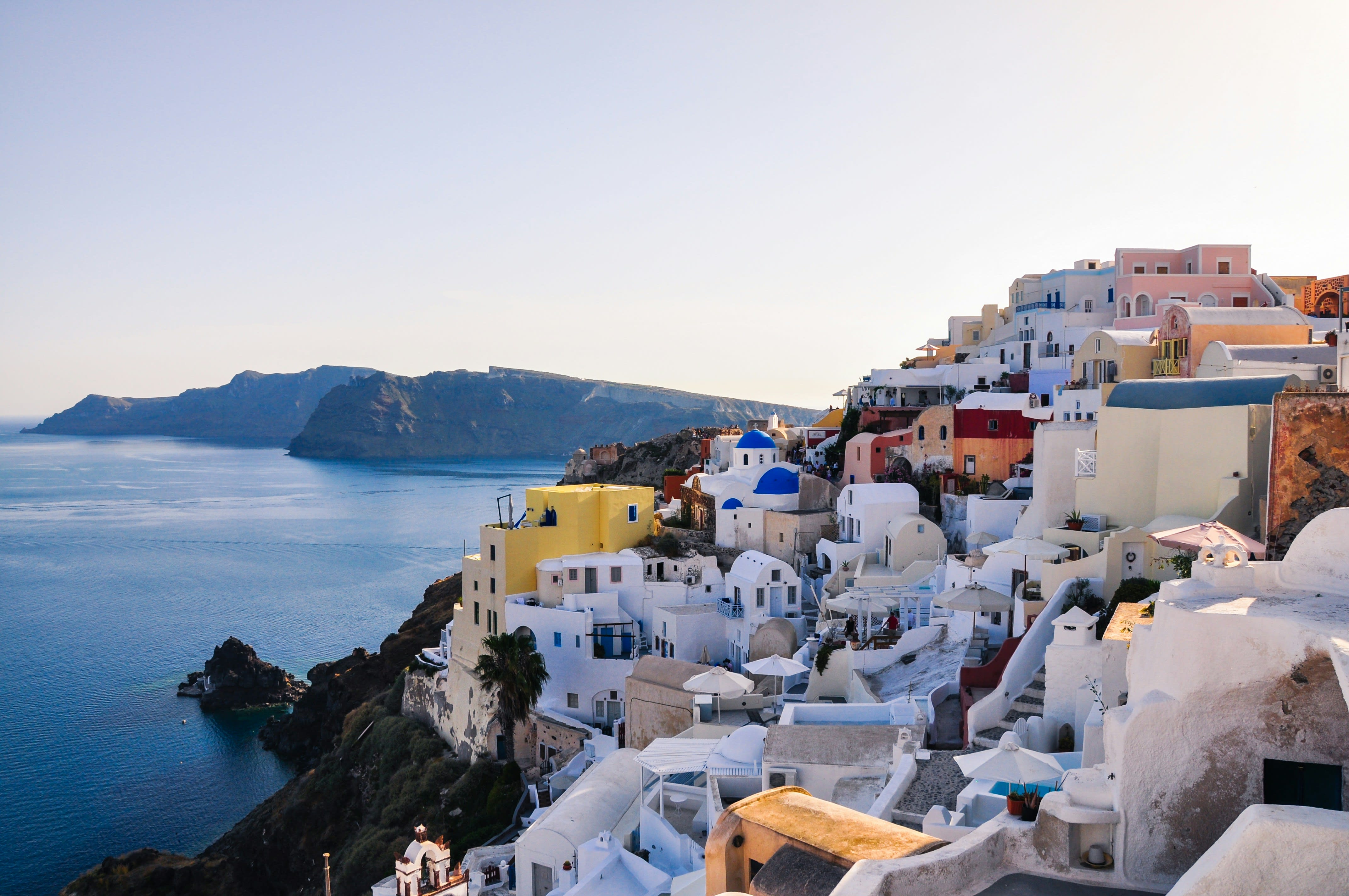 Classic Santorini caldera view, white buildings and blue domes above the sea