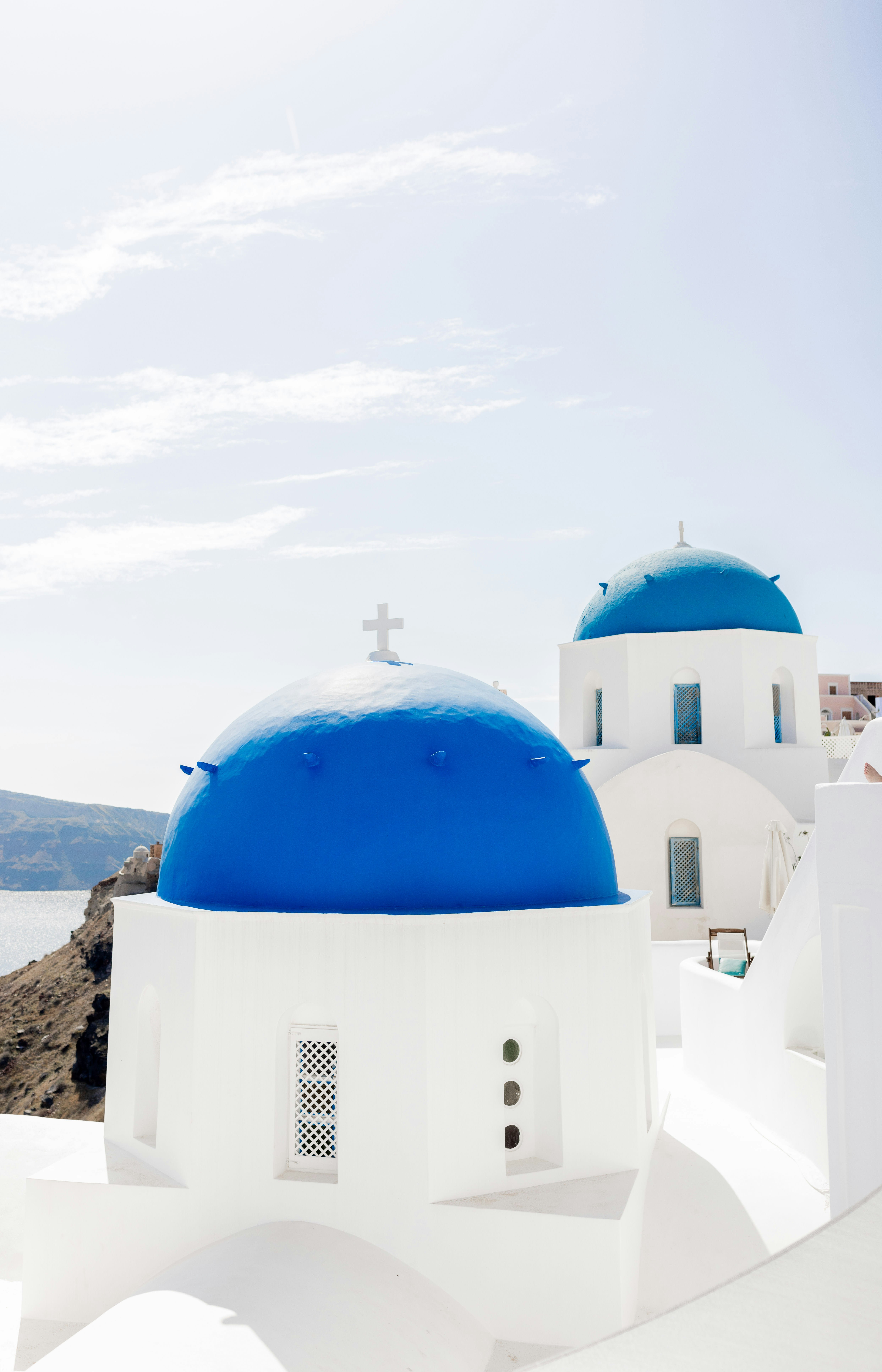 A classic Cycladic island view — white village, blue domes, sea