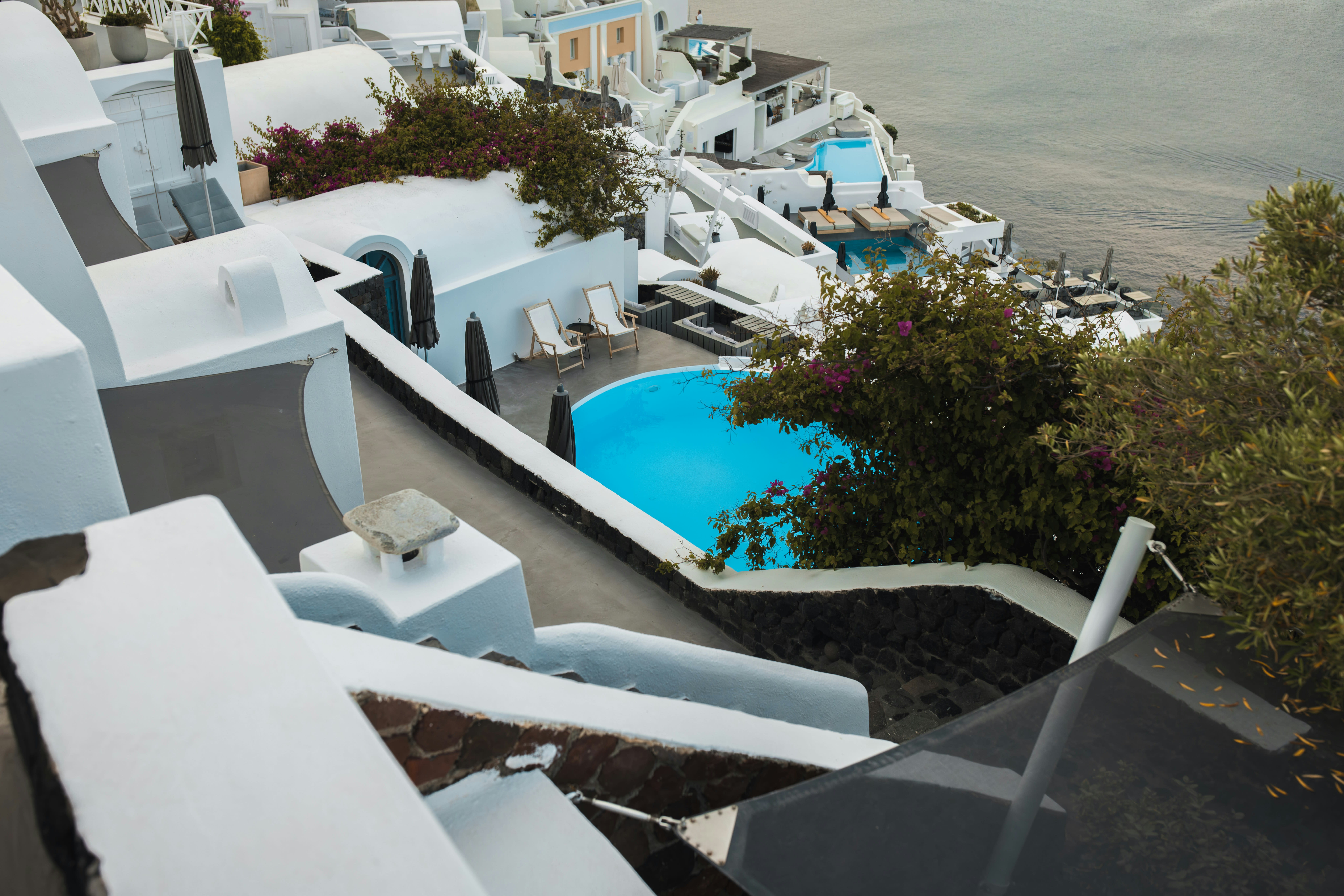 An elegant seaside fine-dining table or a luxury resort pool overlooking the Aegean