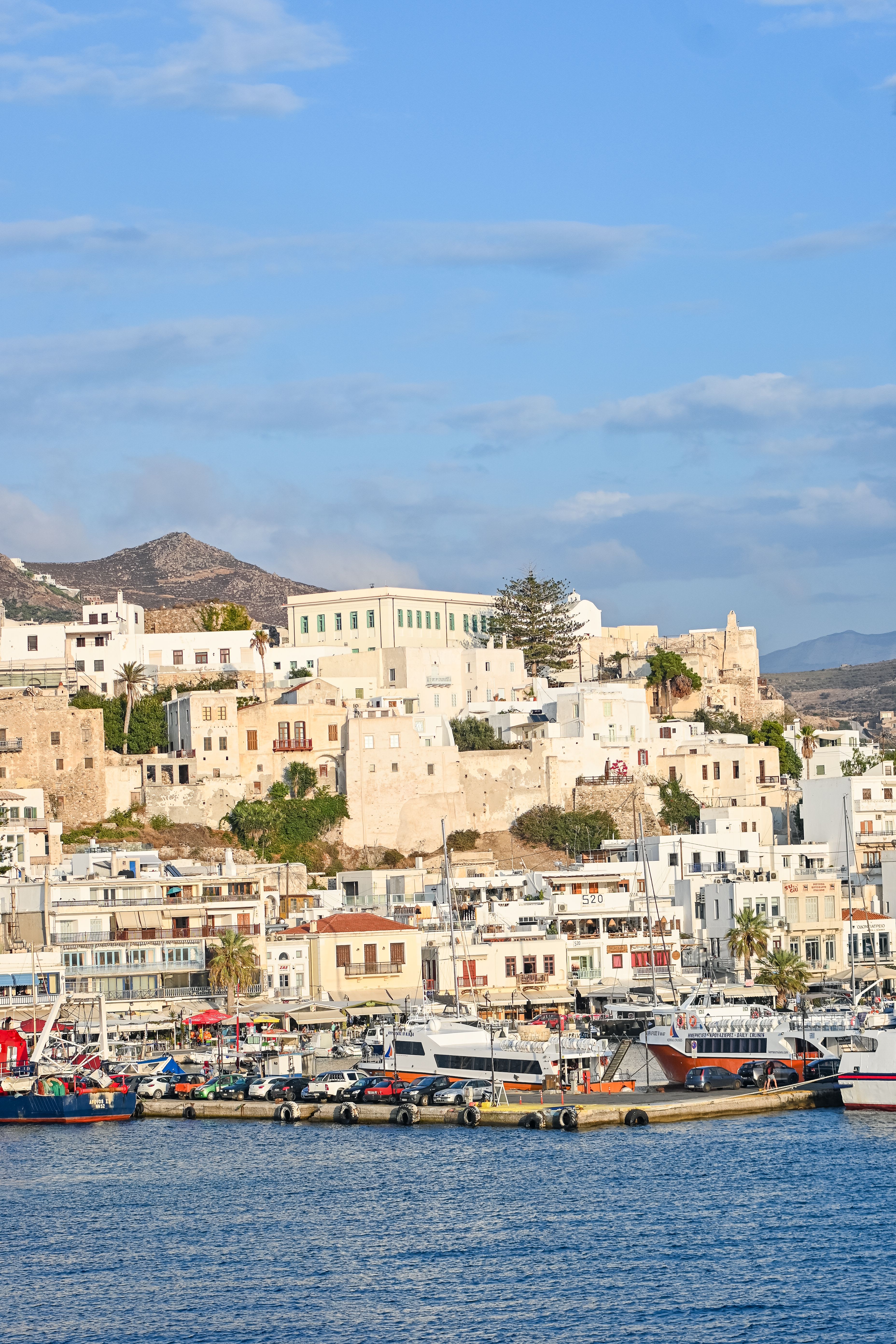 Split image — Naxos Portara/mountains vs Naoussa harbor on Paros