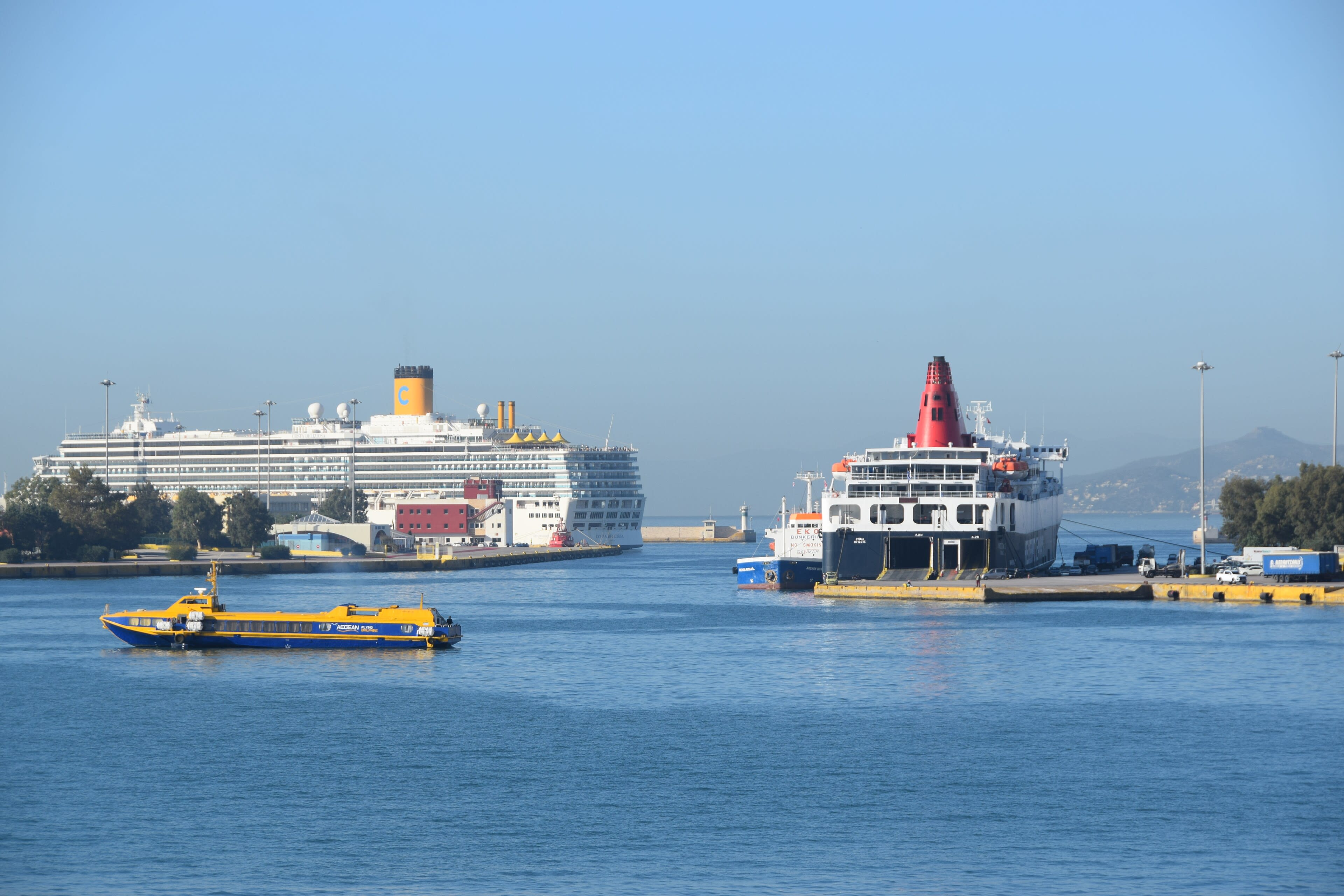A wide view of the busy Piraeus harbor with multiple ferries docked