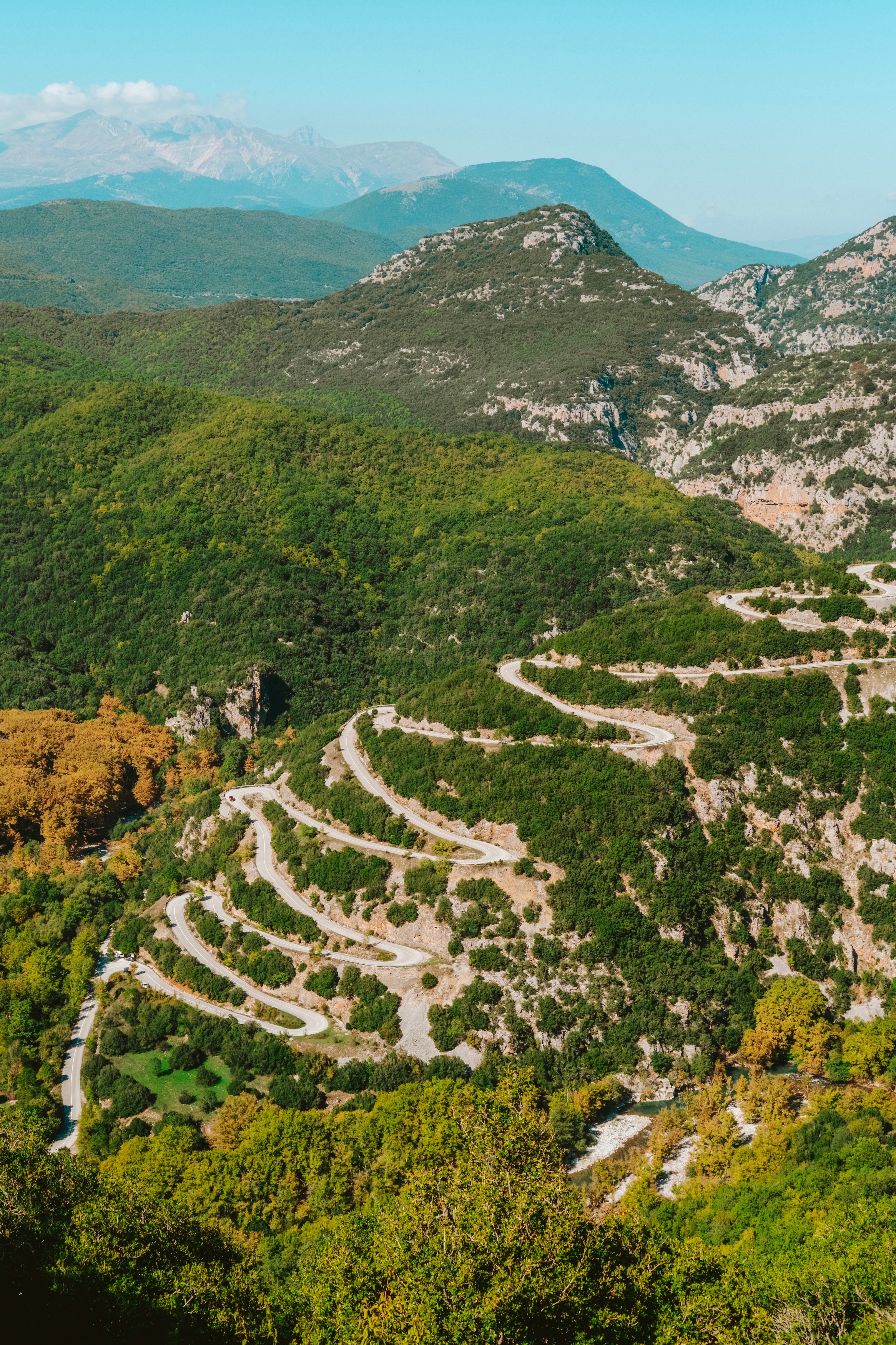 A scenic Greek coastal or mountain road winding through the landscape