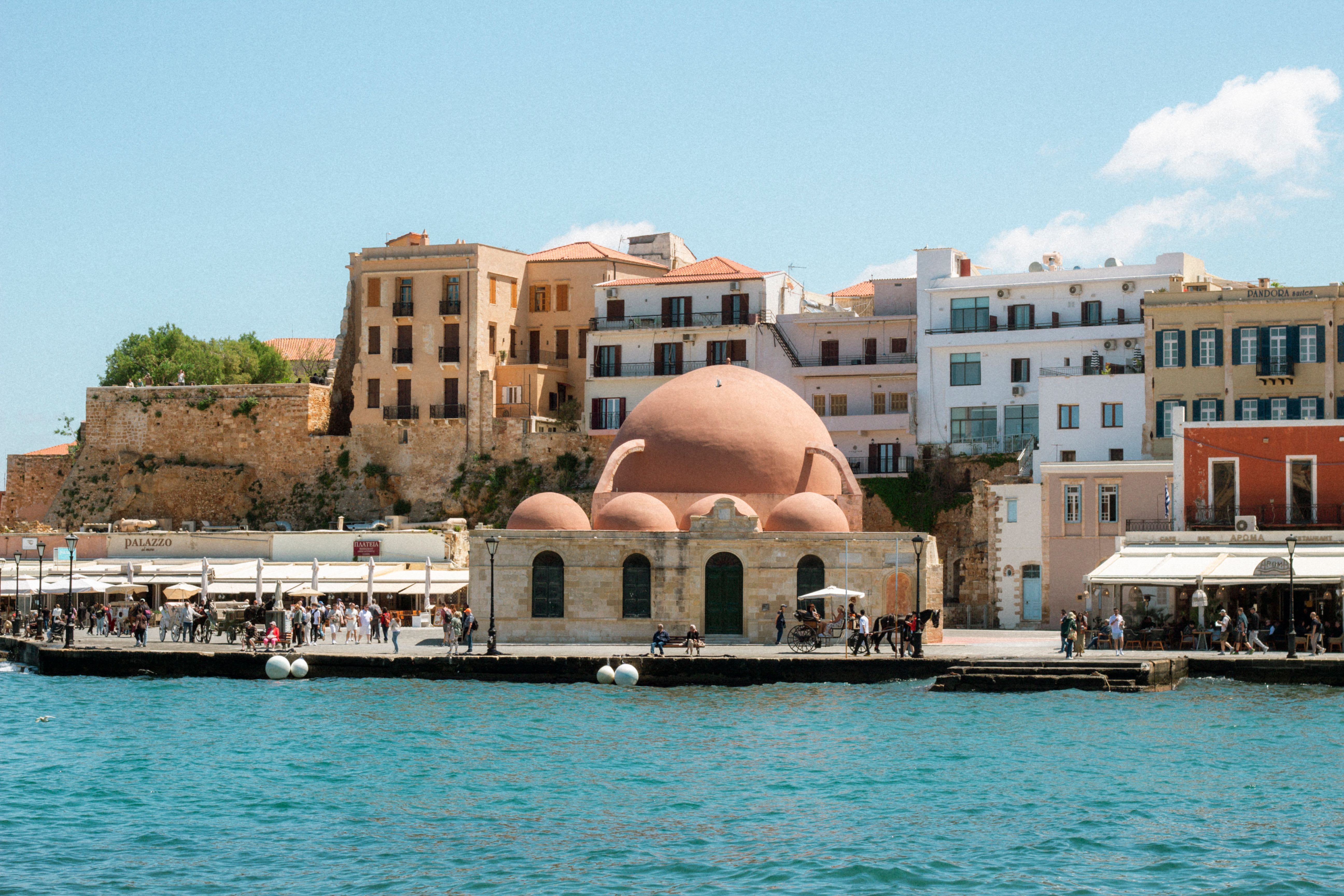 Chania's Venetian harbour at golden hour, old lighthouse and waterfront