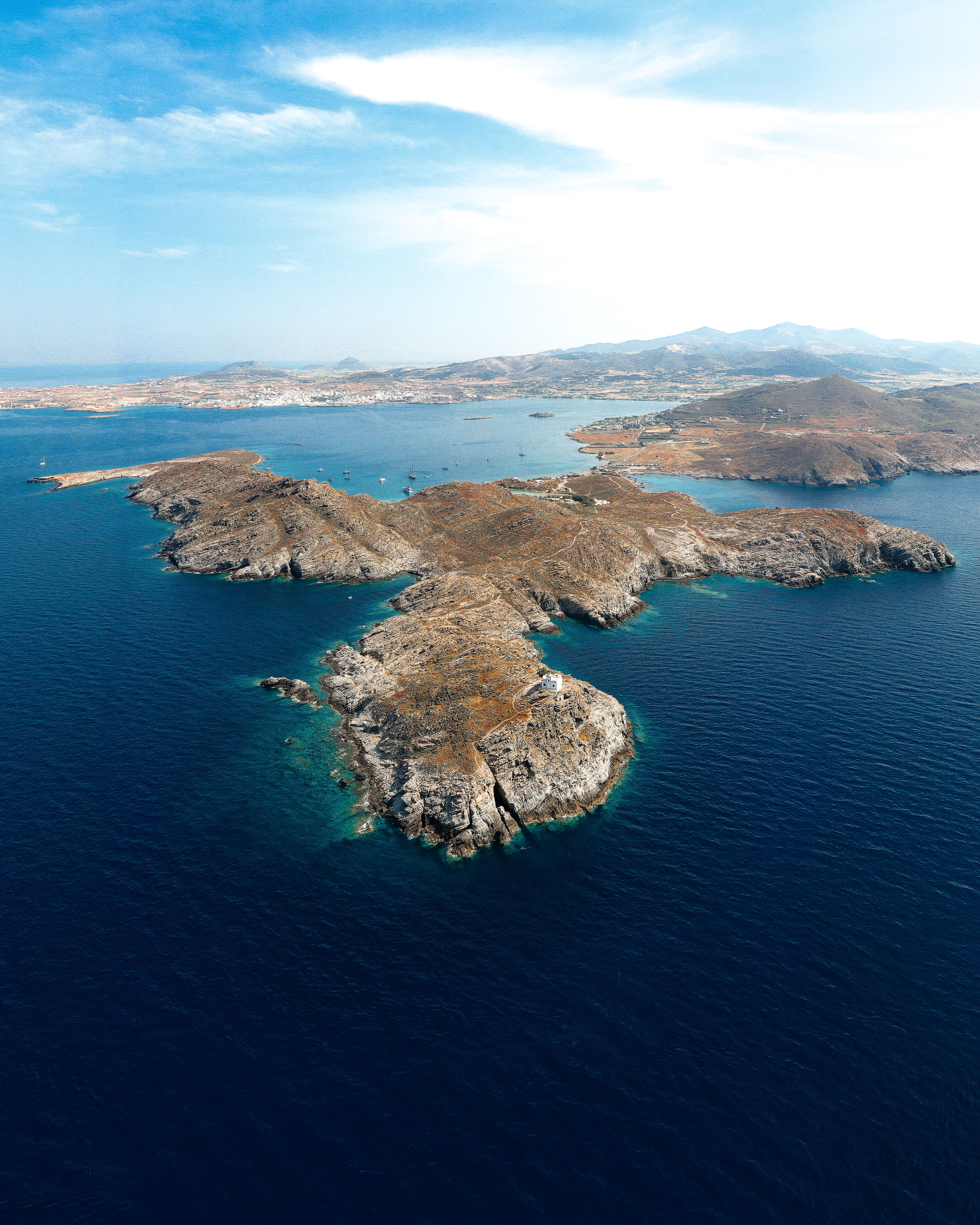 A map-like aerial of Cycladic islands scattered across blue Aegean sea