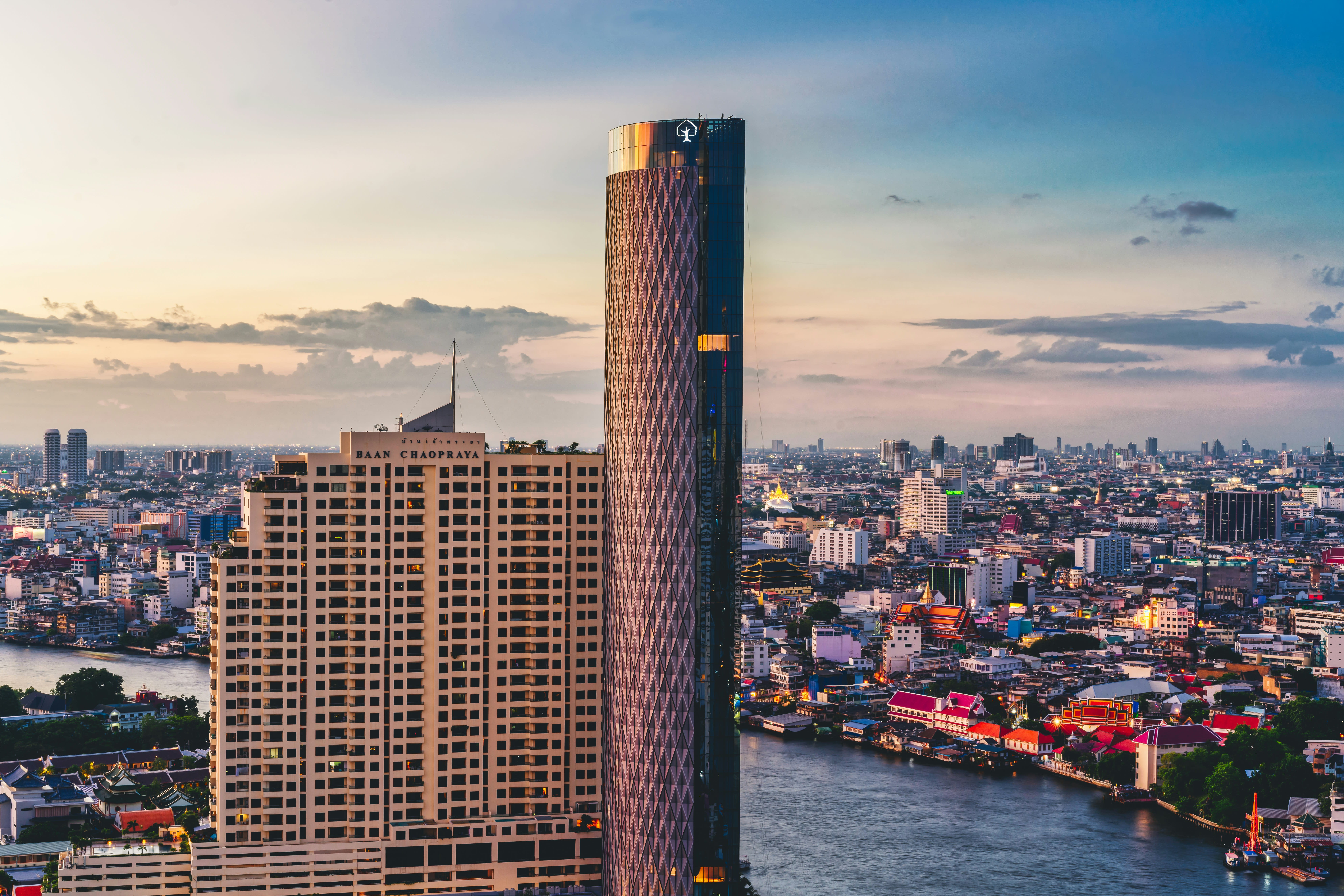 A riverside Bangkok hotel pool overlooking the Chao Phraya River and temples
