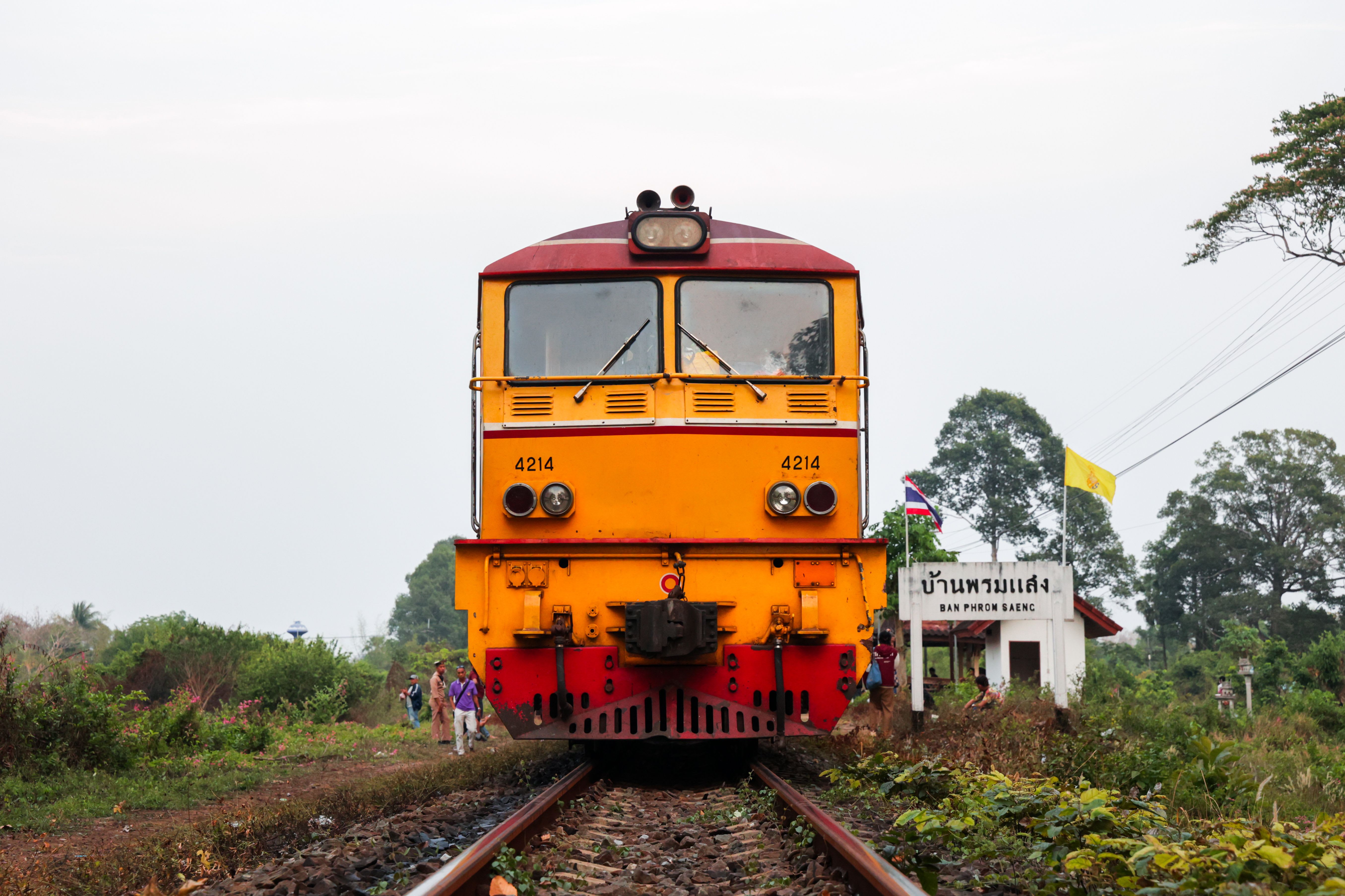 A Thai train winding through green countryside
