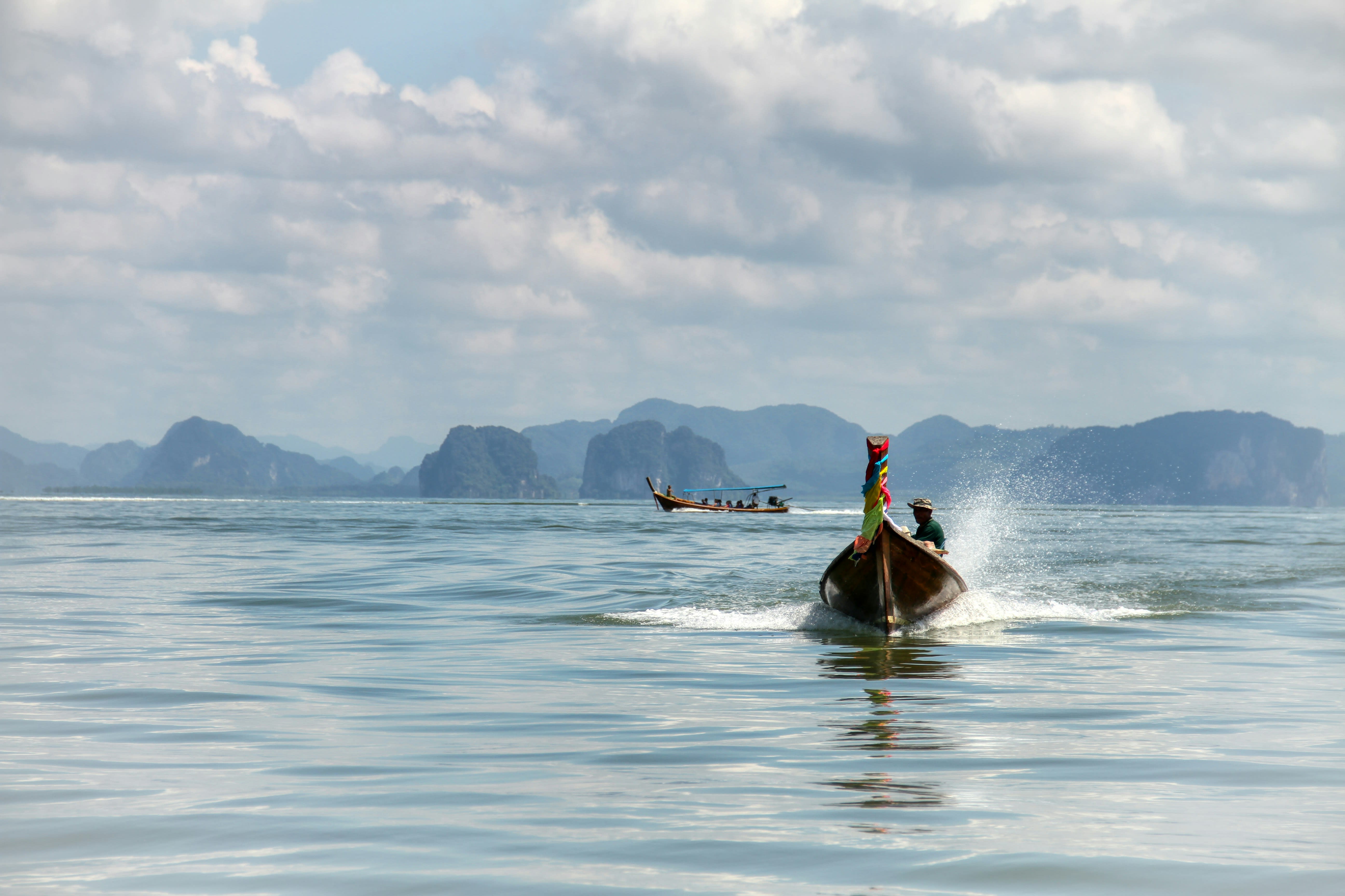 A longtail boat among the limestone karsts of Phang Nga Bay