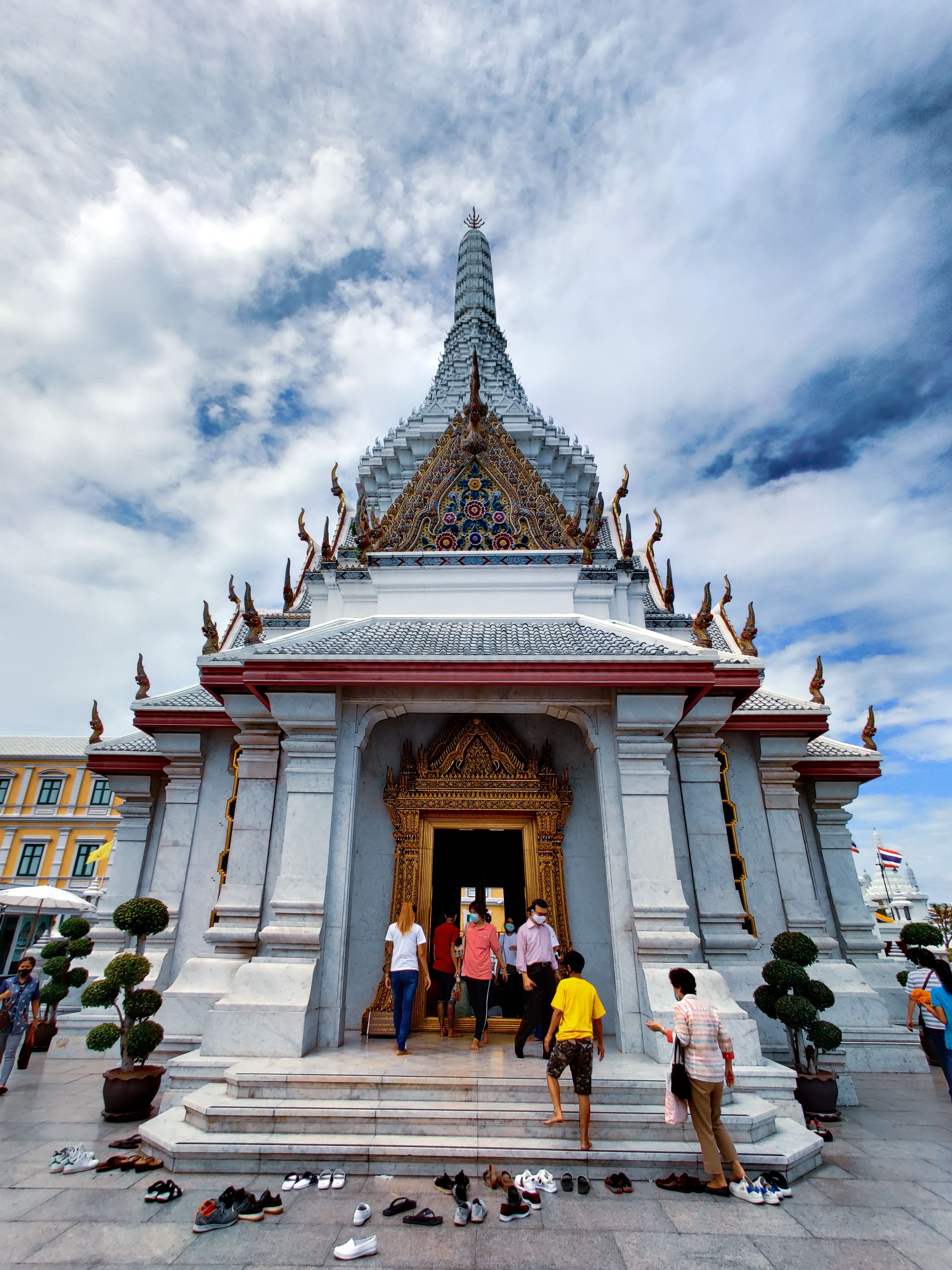 People removing shoes outside a temple or home