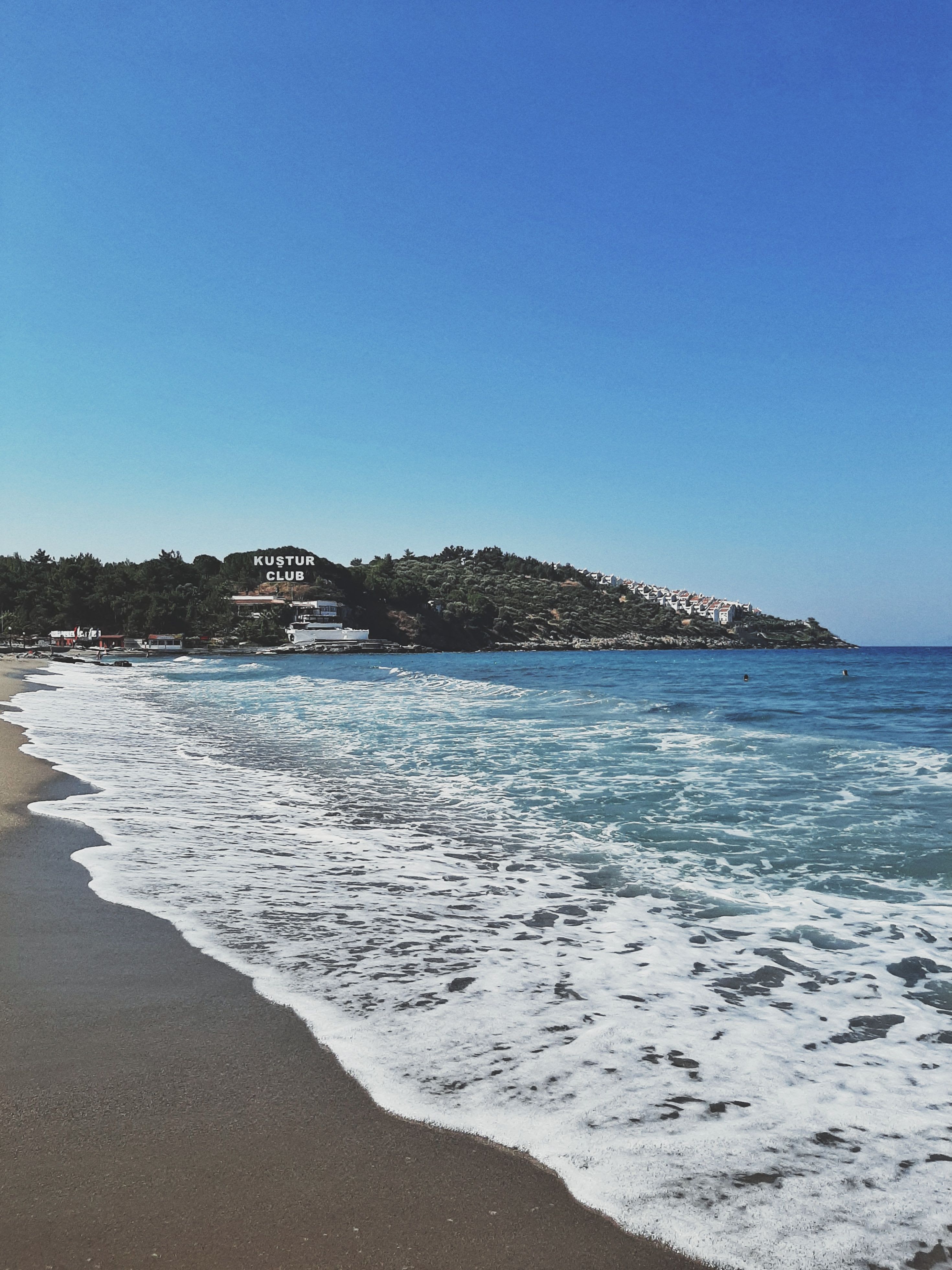 Pigeon Island fortress connected by causeway at Kusadasi, blue Aegean water