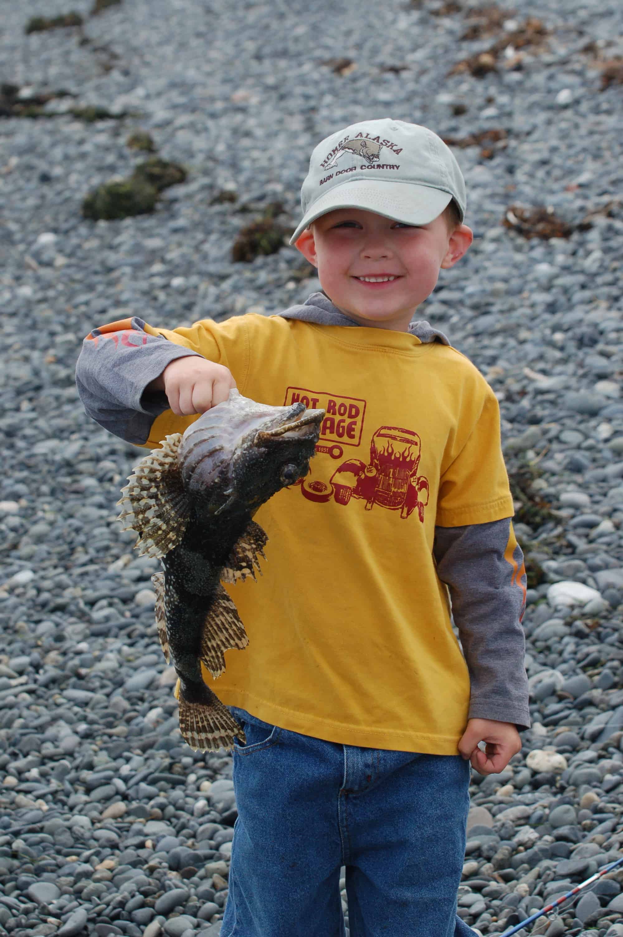 A four-year-old boy with his very first catch