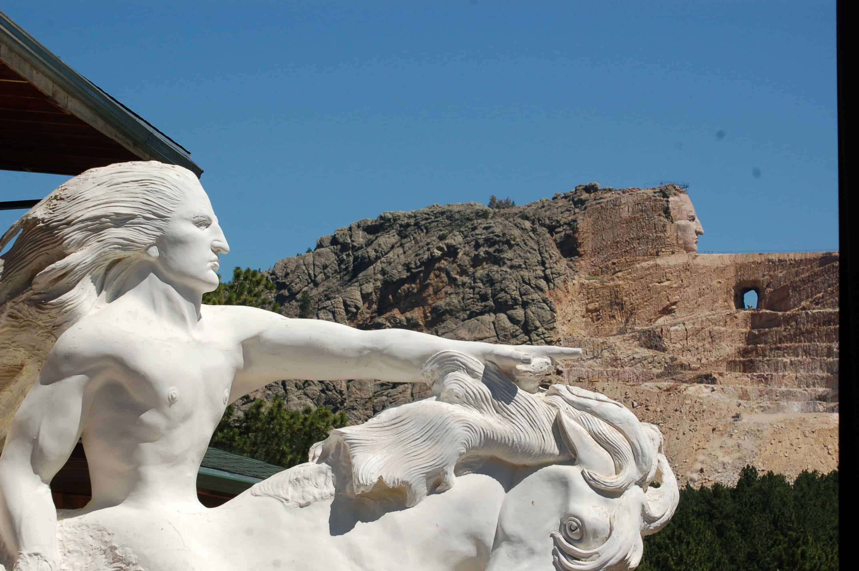 The sculptor's model alongside the current state of the mountain carving