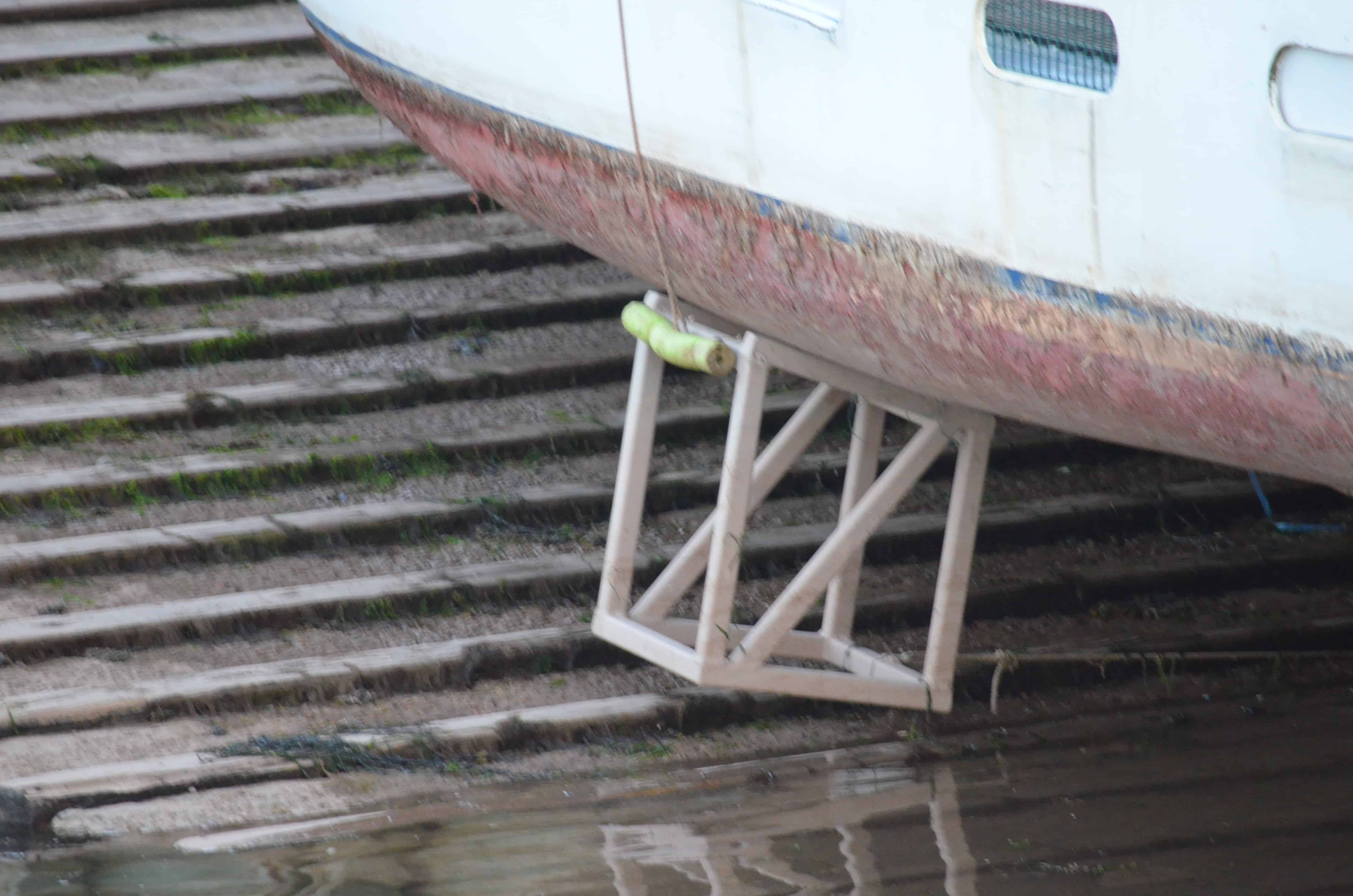 Wooden braces holding a boat upright at low tide