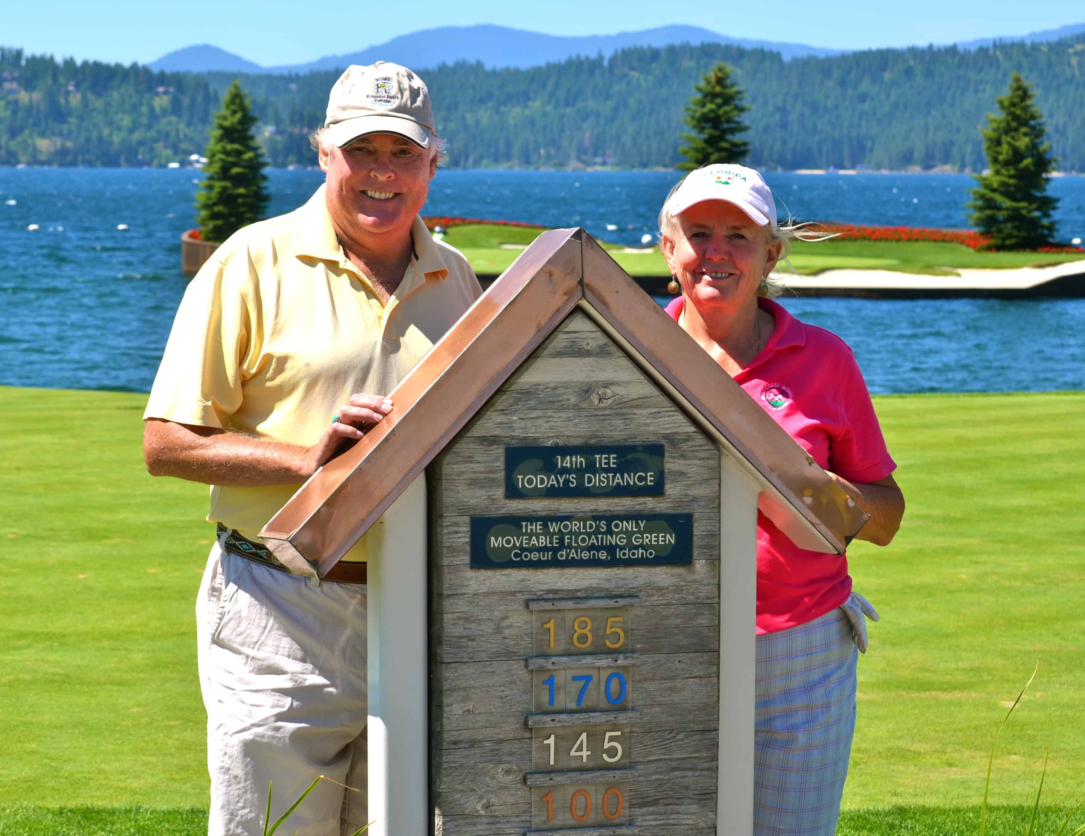 Janice and John at the floating-green tee sign