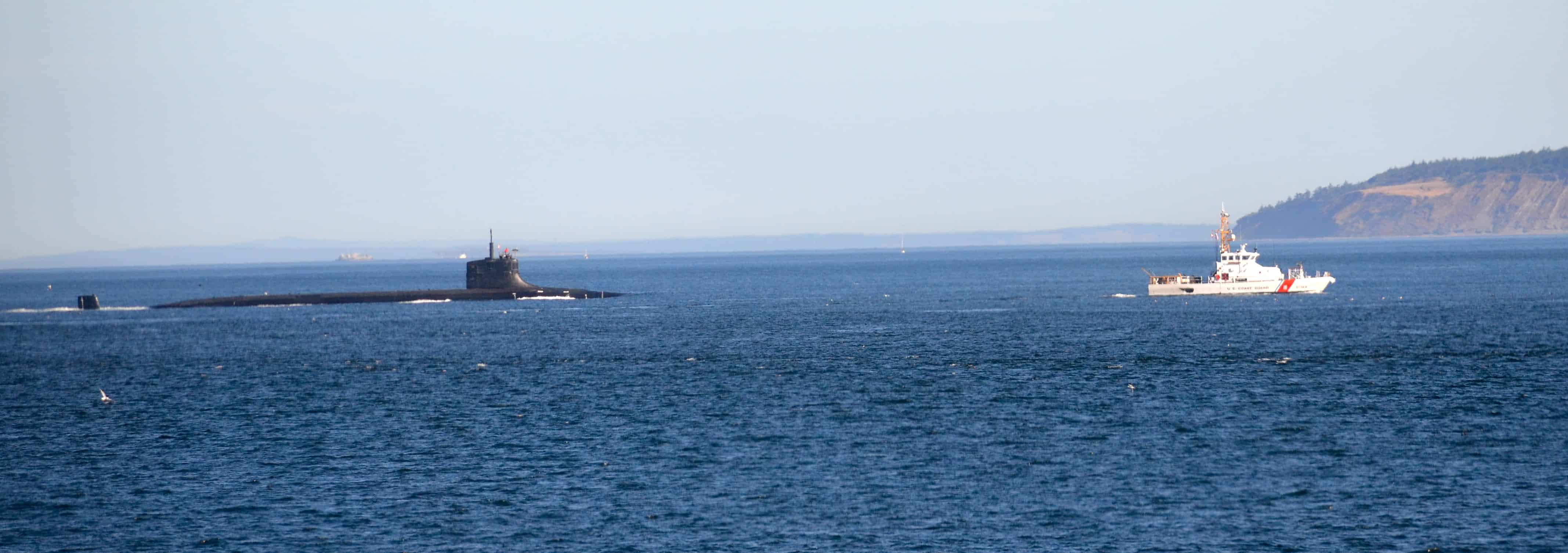 A Navy submarine, Coast Guard escort