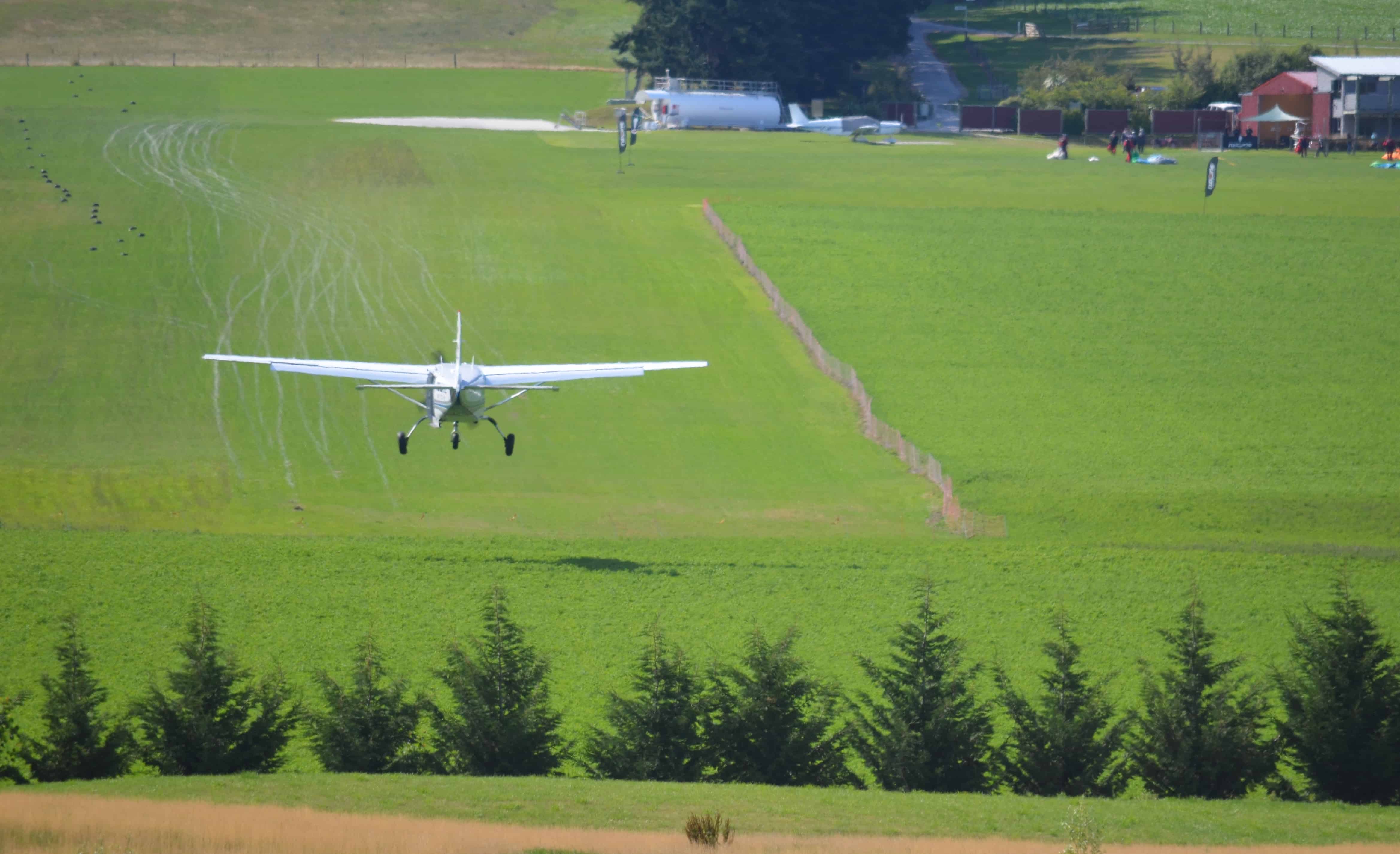 Airplane landing on the strip below the second tee