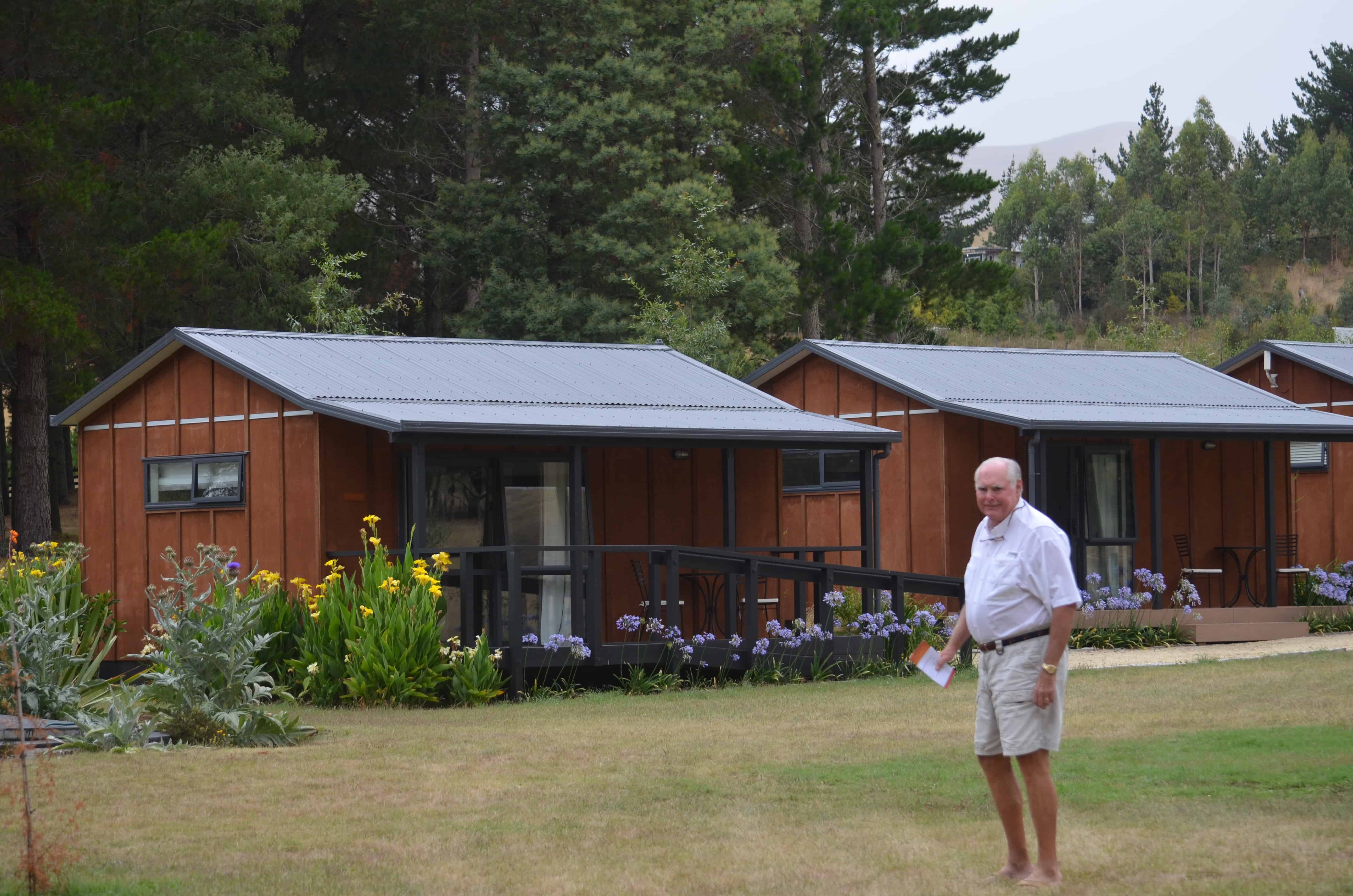 John outside the cabins