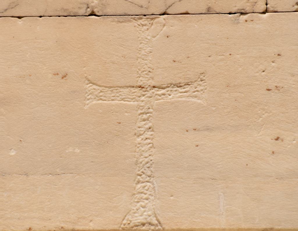 A cross cut into an ancient Acropolis stone