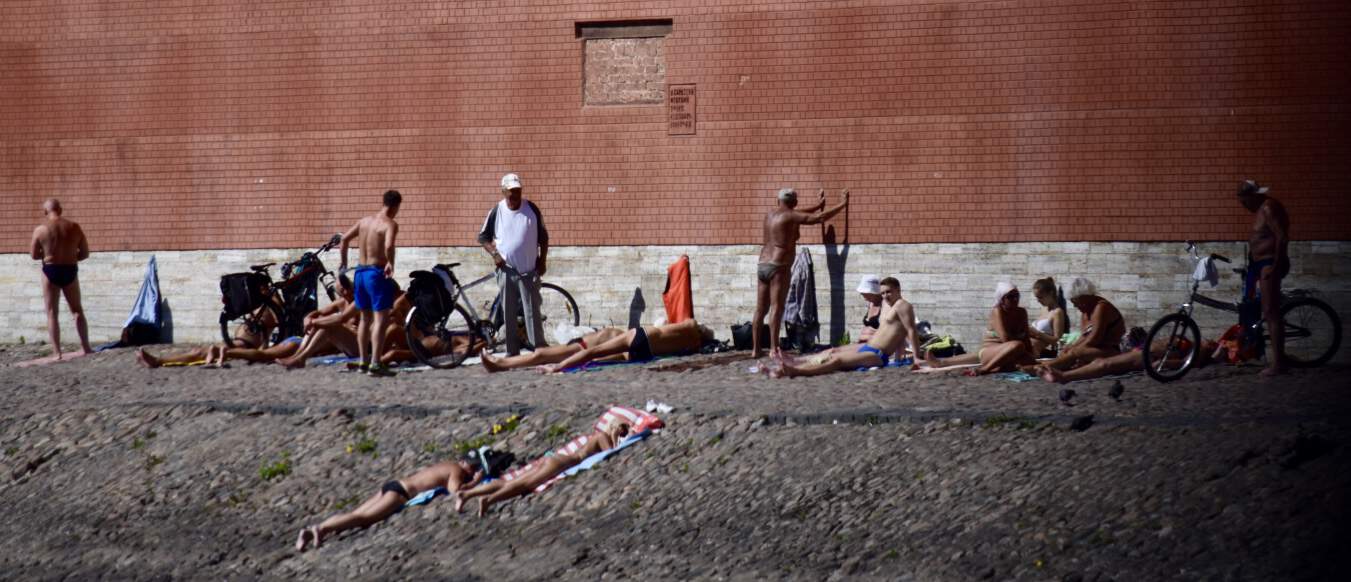 Sunbathers along the wall of the Peter and Paul Fortress
