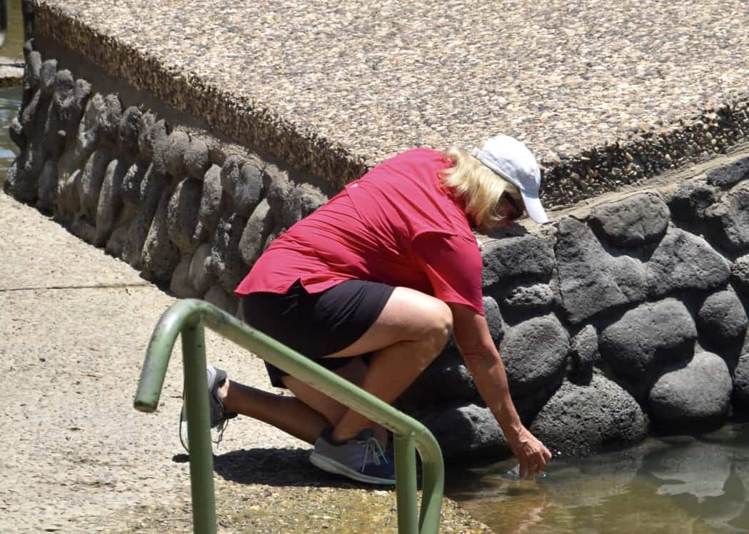 Janice taking water from the Jordan