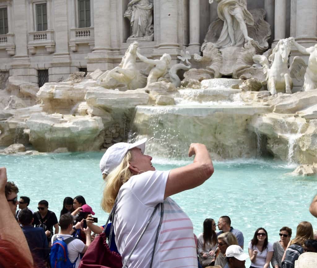 Janice throwing her coin into the Trevi Fountain