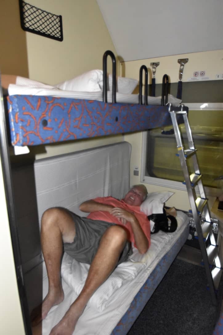 John in the bunk-bed sleeper car to Warsaw