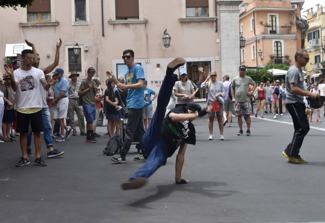 Children dancing for the tourists in Taormina