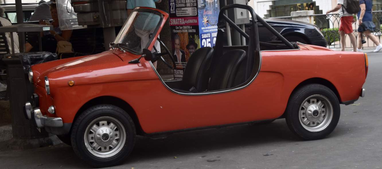 The tiny red car on the narrow streets