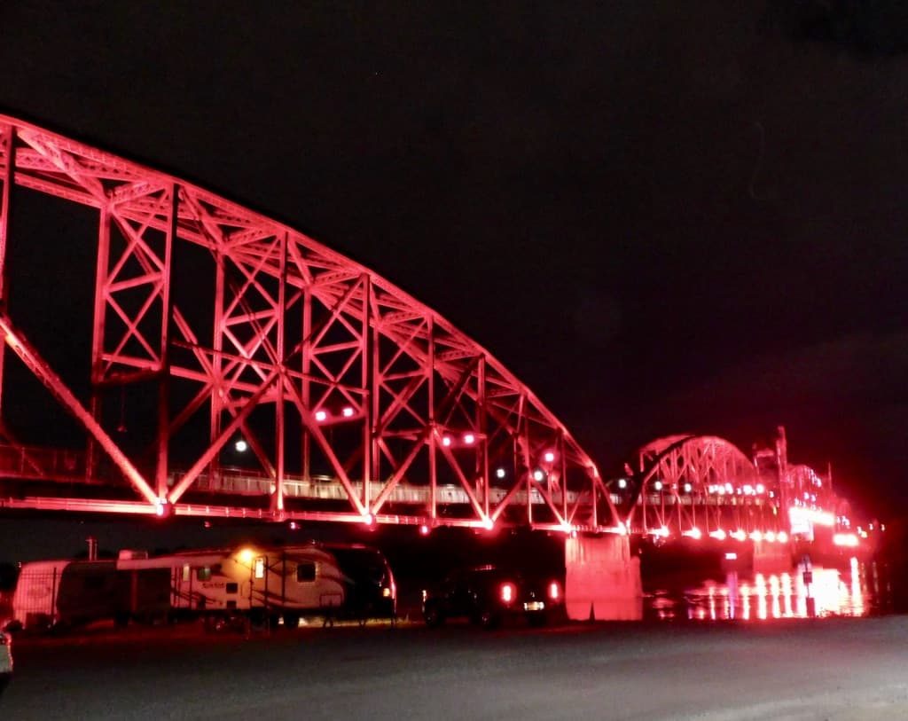 The old train bridge lit at night