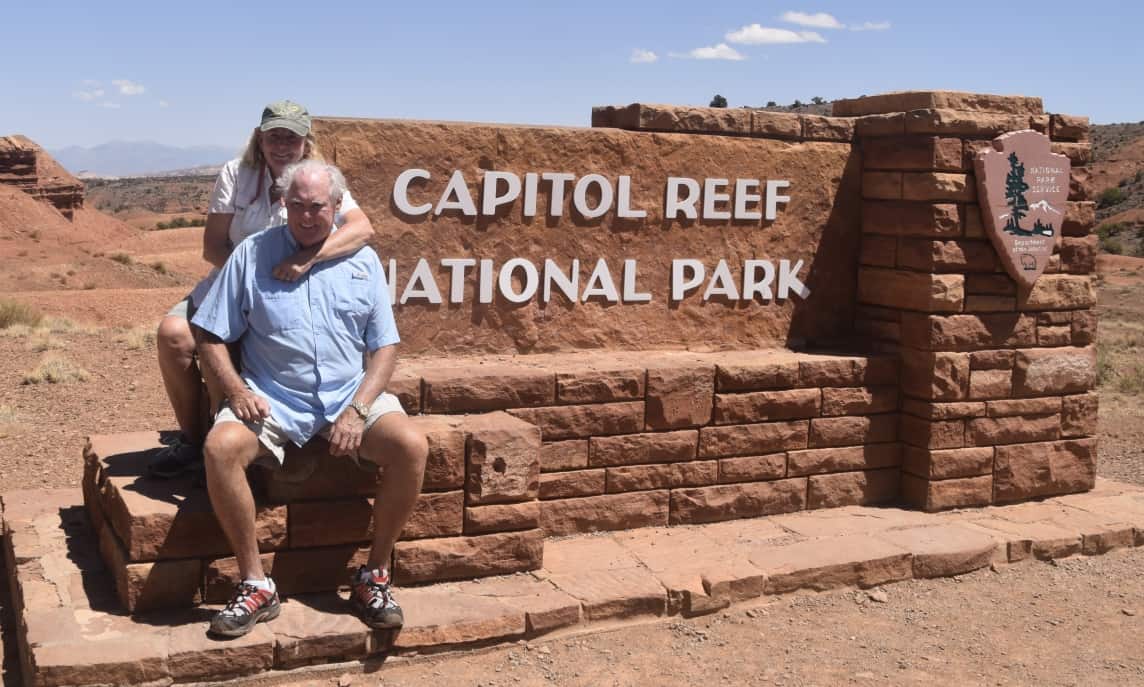 Janice and John at the Capitol Reef National Park entrance sign