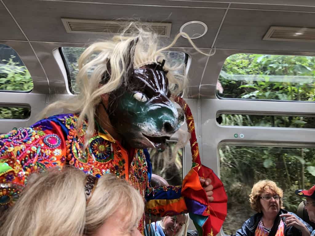 Costumed dancers on the train