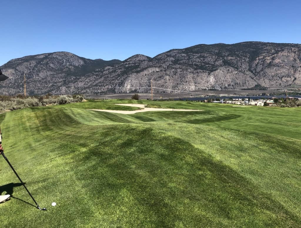 The lake and mountains behind the Desert Course