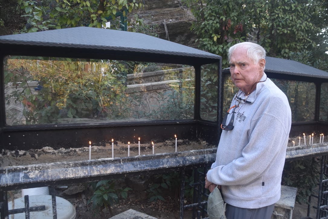 John lighting a candle at Mary's House