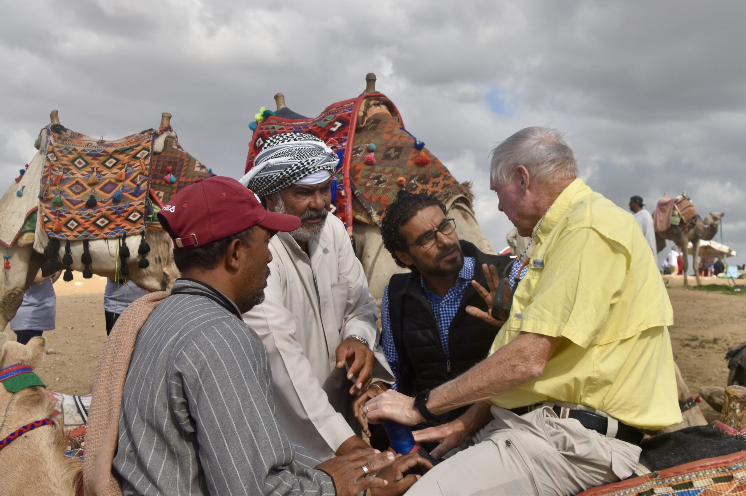 Sam and the crew getting John onto his camel