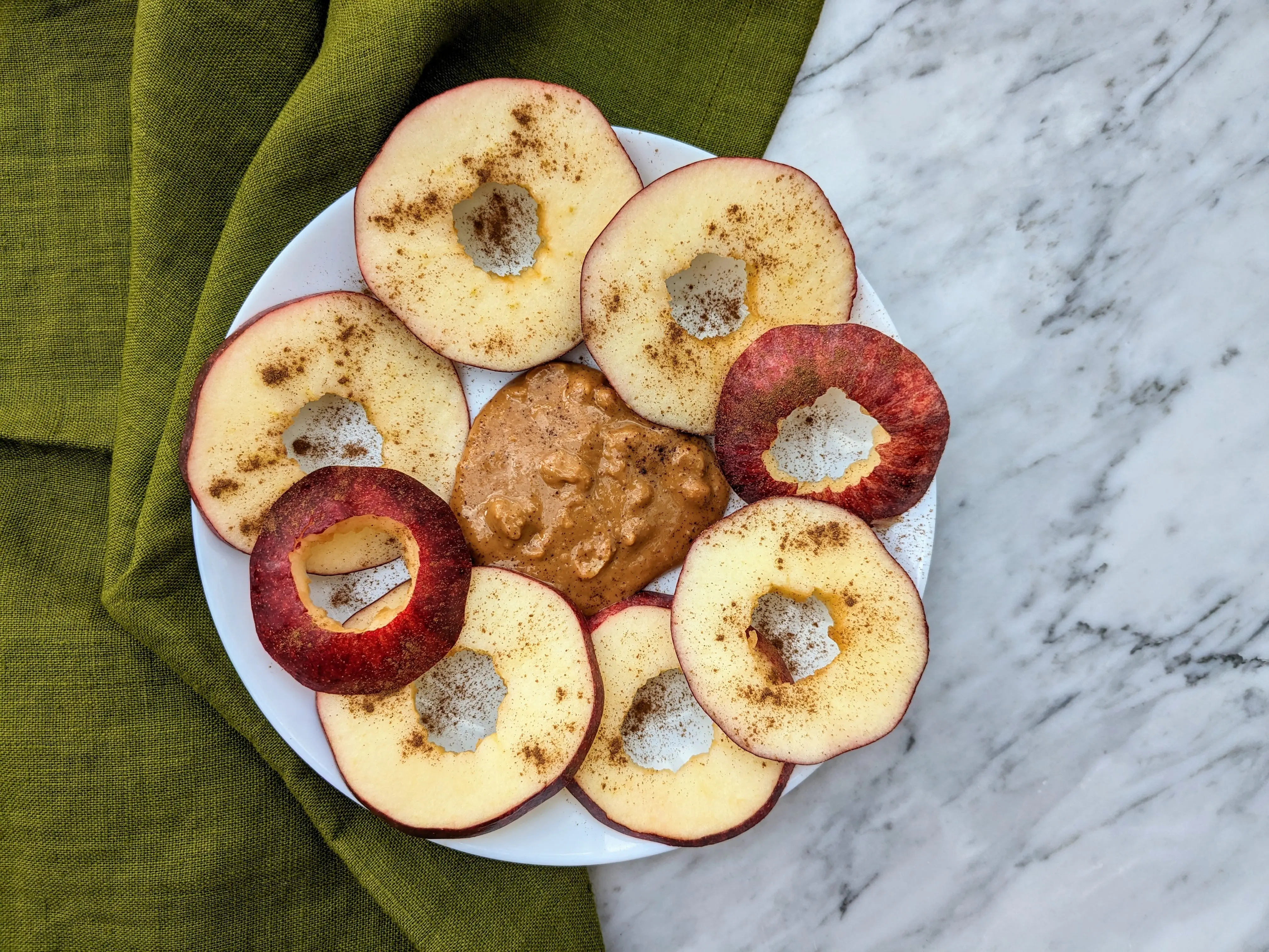 Vegan apple rings with peanut butter and cinnamon