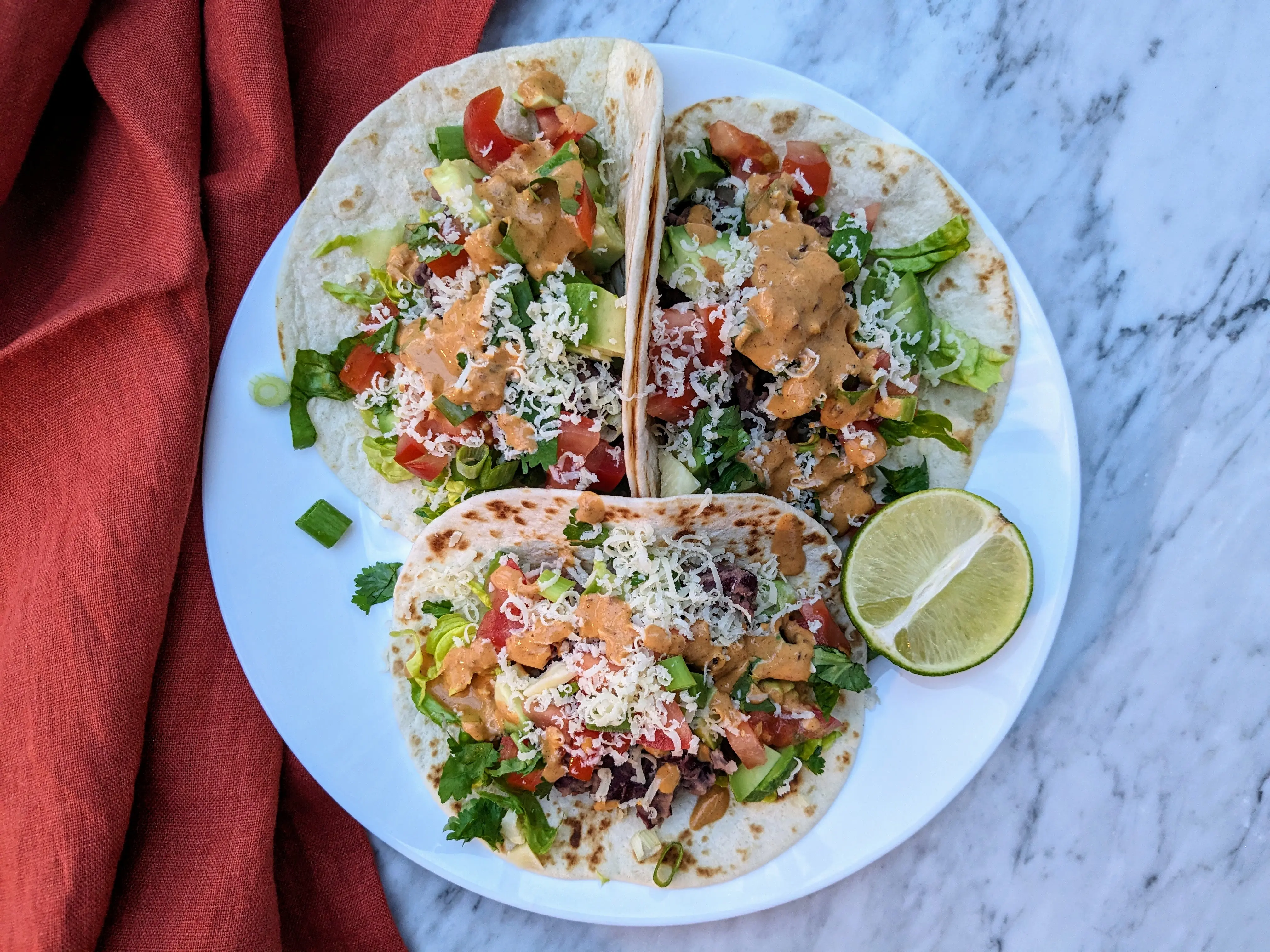 Cheesy avocado and beans tacos
