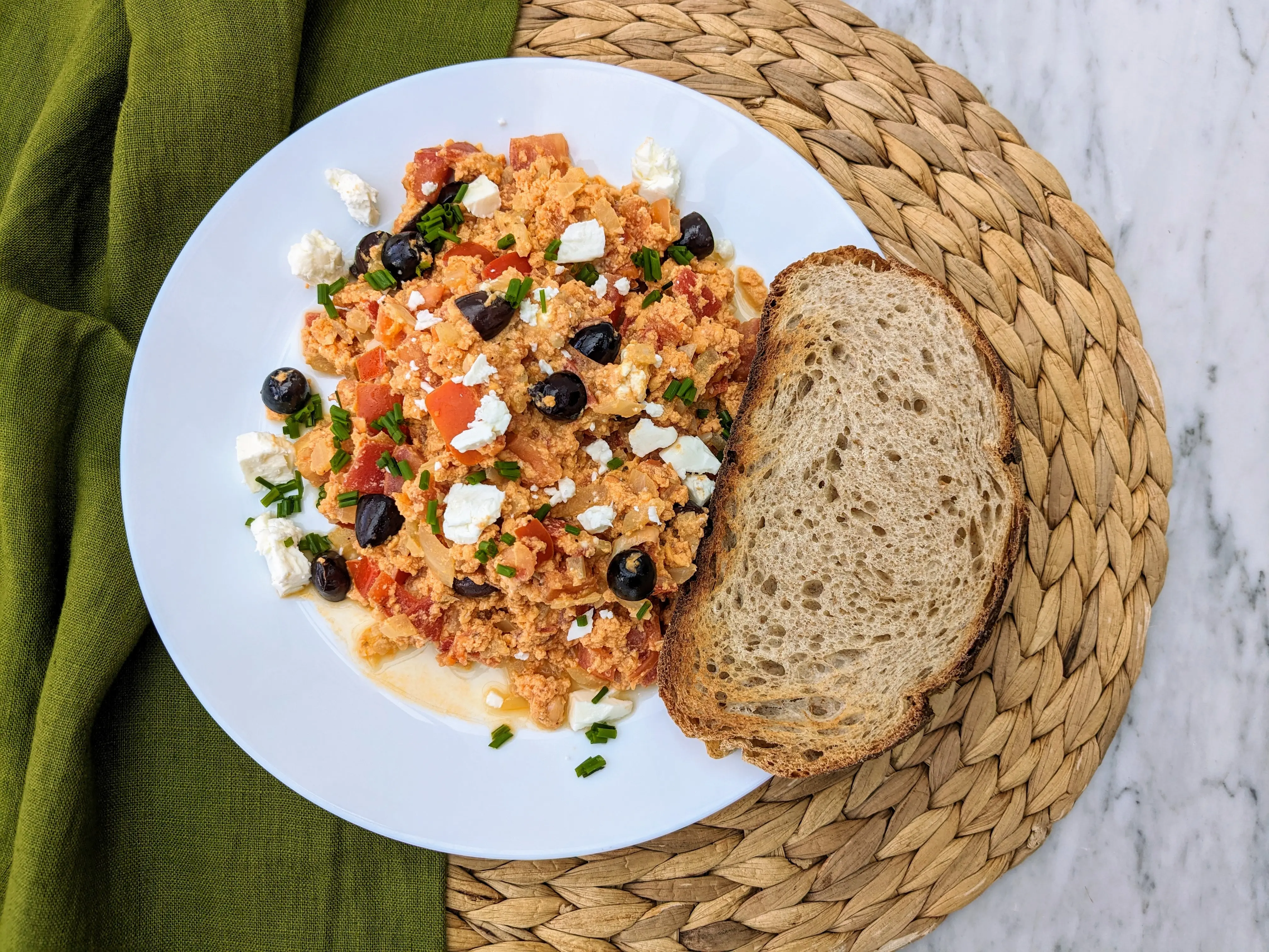 Greek scrambled eggs (Strapatsada) with tomatoes, olives and feta