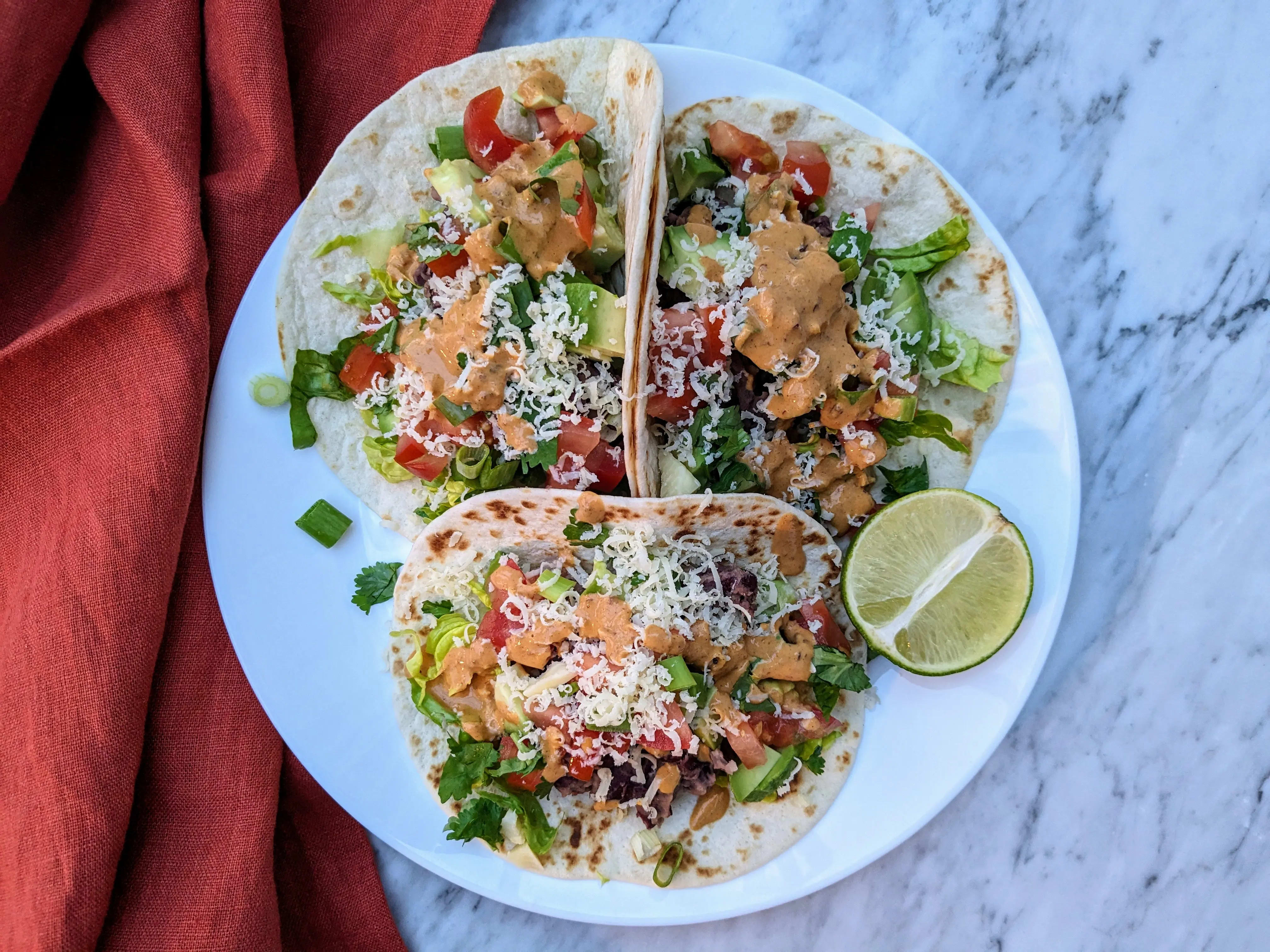Photo of Cheesy avocado and beans tacos