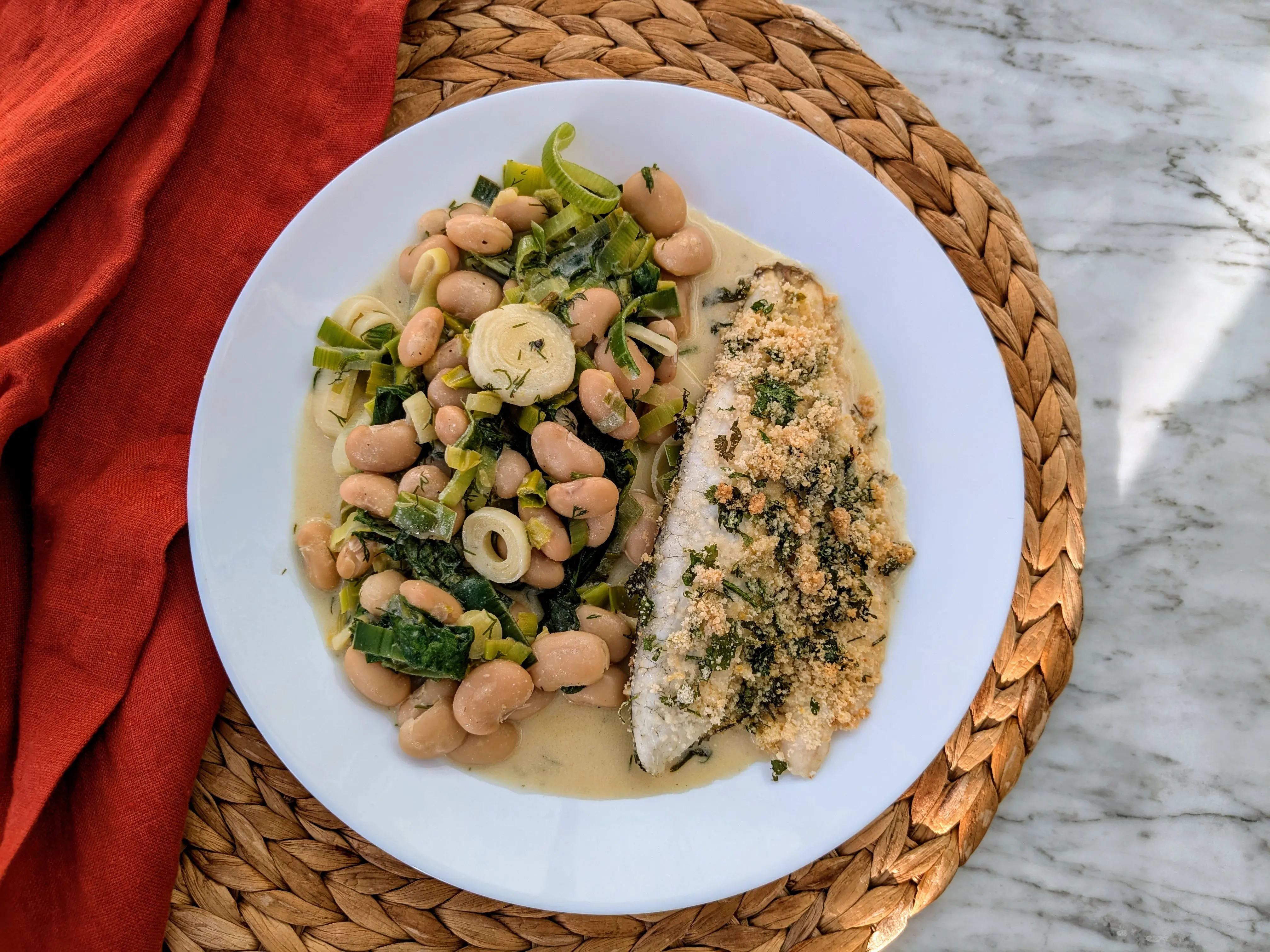 Photo of Crusty sea bass with creamy leeks and herby butter beans