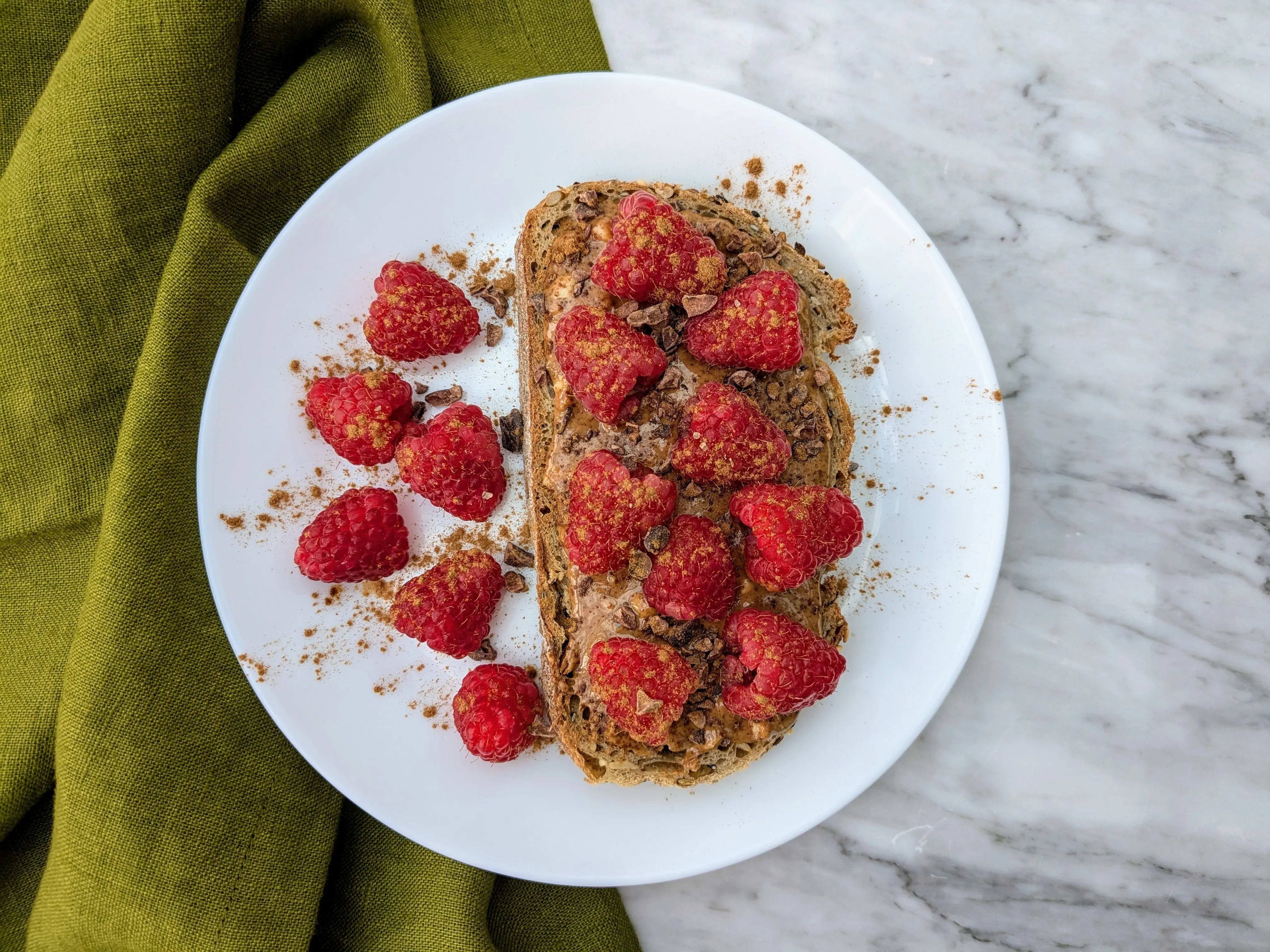 Photo of Vegan raspberries and almond butter on sourdough toast
