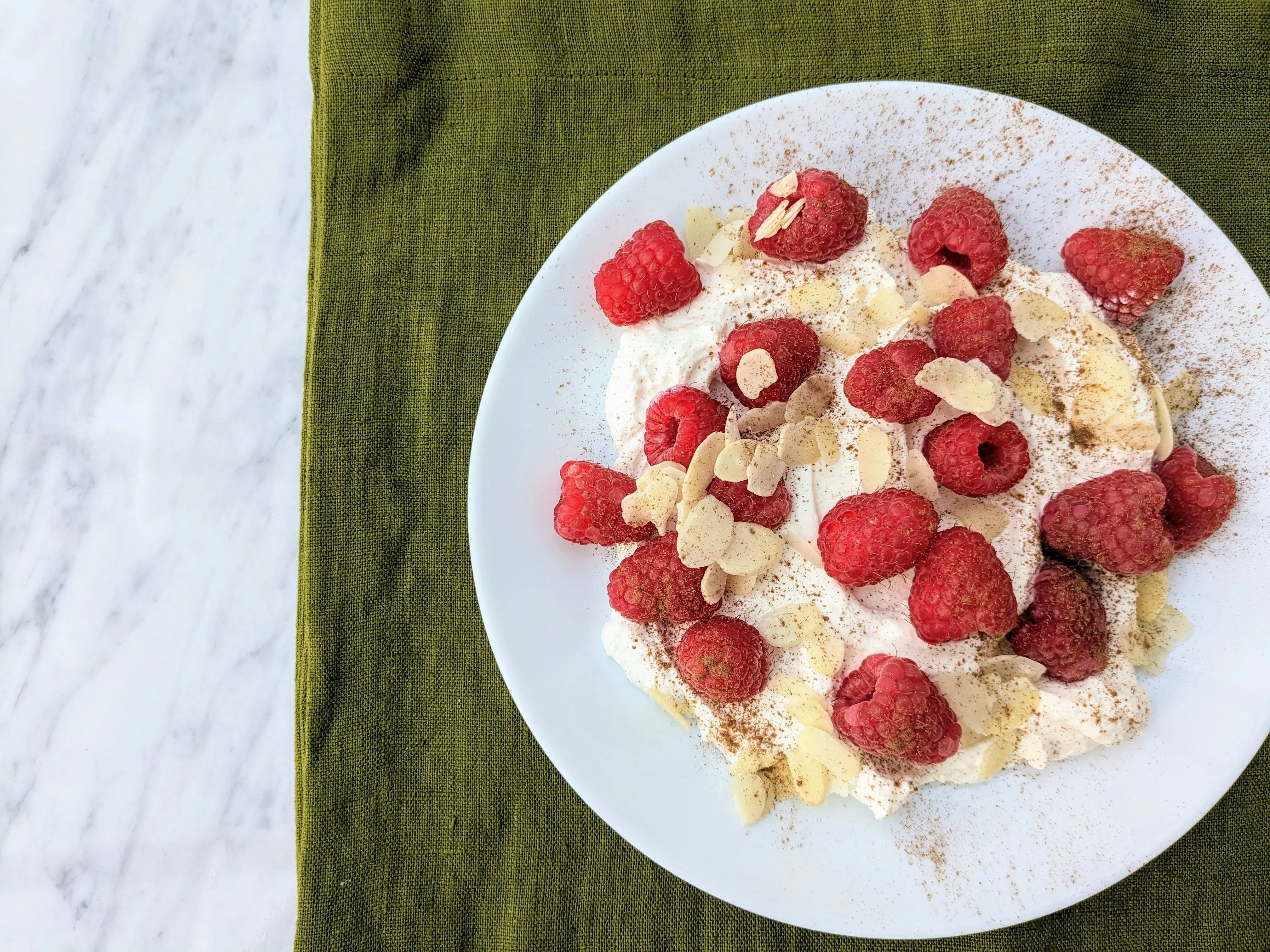 Photo of Ricotta with fresh raspberries and flaked almonds